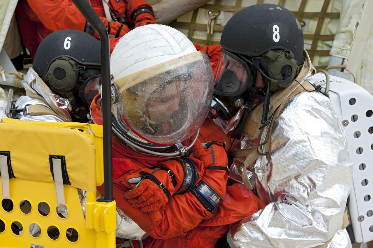 CAPE CANAVERAL, Fla. – An emergency exit, or Mode II/IV, exercise is under way at the slidewire basket landing site of Launch Pad 39A at NASA's Kennedy Space Center in Florida. The exercise involves NASA fire rescue personnel, volunteers portraying astronauts with simulated injuries, helicopters and personnel from the Air Force’s 920th Rescue Wing, and medical trauma teams at three Central Florida hospitals. The drill allows teams to practice an emergency response at the launch pad, including helicopter evacuation to local hospitals.       Photo credit: NASA/Kim Shiflett