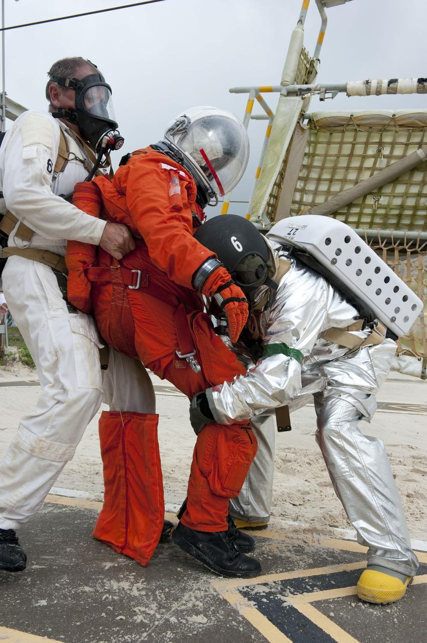 CAPE CANAVERAL, Fla. – An emergency exit, or Mode II/IV, exercise is under way at the slidewire basket landing site of Launch Pad 39A at NASA's Kennedy Space Center in Florida. The exercise involves NASA fire rescue personnel, volunteers portraying astronauts with simulated injuries, helicopters and personnel from the Air Force’s 920th Rescue Wing, and medical trauma teams at three Central Florida hospitals. The drill allows teams to practice an emergency response at the launch pad, including helicopter evacuation to local hospitals.   Photo credit: NASA/Kim Shiflett