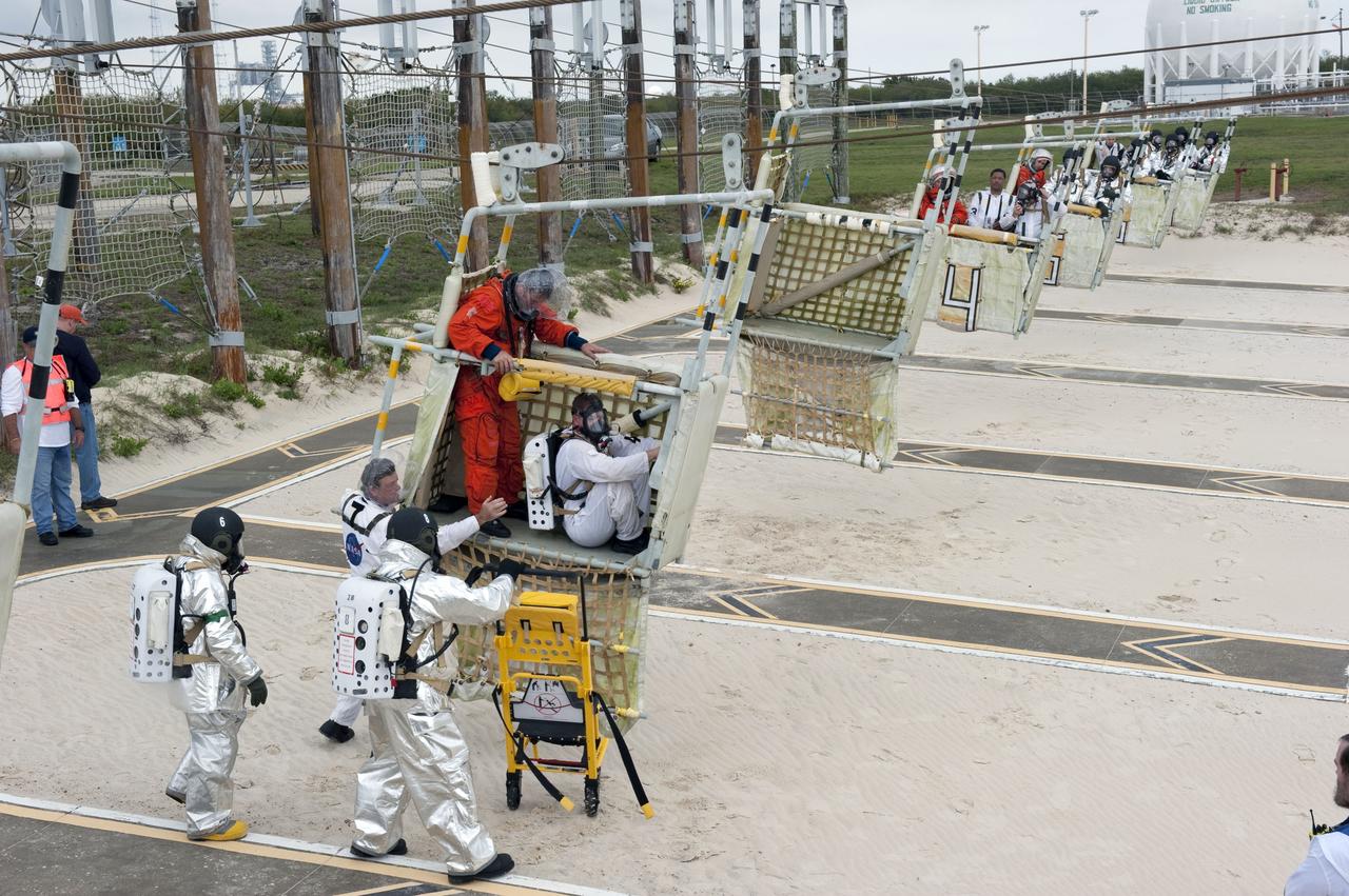 CAPE CANAVERAL, Fla. – An emergency exit, or Mode II/IV, exercise is under way at the slidewire basket landing site of Launch Pad 39A at NASA's Kennedy Space Center in Florida. The exercise involves NASA fire rescue personnel, volunteers portraying astronauts with simulated injuries, helicopters and personnel from the Air Force’s 920th Rescue Wing, and medical trauma teams at three Central Florida hospitals. The drill allows teams to practice an emergency response at the launch pad, including helicopter evacuation to local hospitals.               Photo credit: NASA/Kim Shiflett