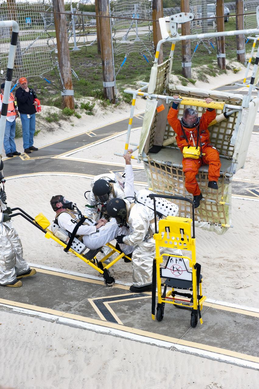CAPE CANAVERAL, Fla. – An emergency exit, or Mode II/IV, exercise is under way at the slidewire basket landing site of Launch Pad 39A at NASA's Kennedy Space Center in Florida. The exercise involves NASA fire rescue personnel, volunteers portraying astronauts with simulated injuries, helicopters and personnel from the Air Force’s 920th Rescue Wing, and medical trauma teams at three Central Florida hospitals. The drill allows teams to practice an emergency response at the launch pad, including helicopter evacuation to local hospitals.             Photo credit: NASA/Kim Shiflett