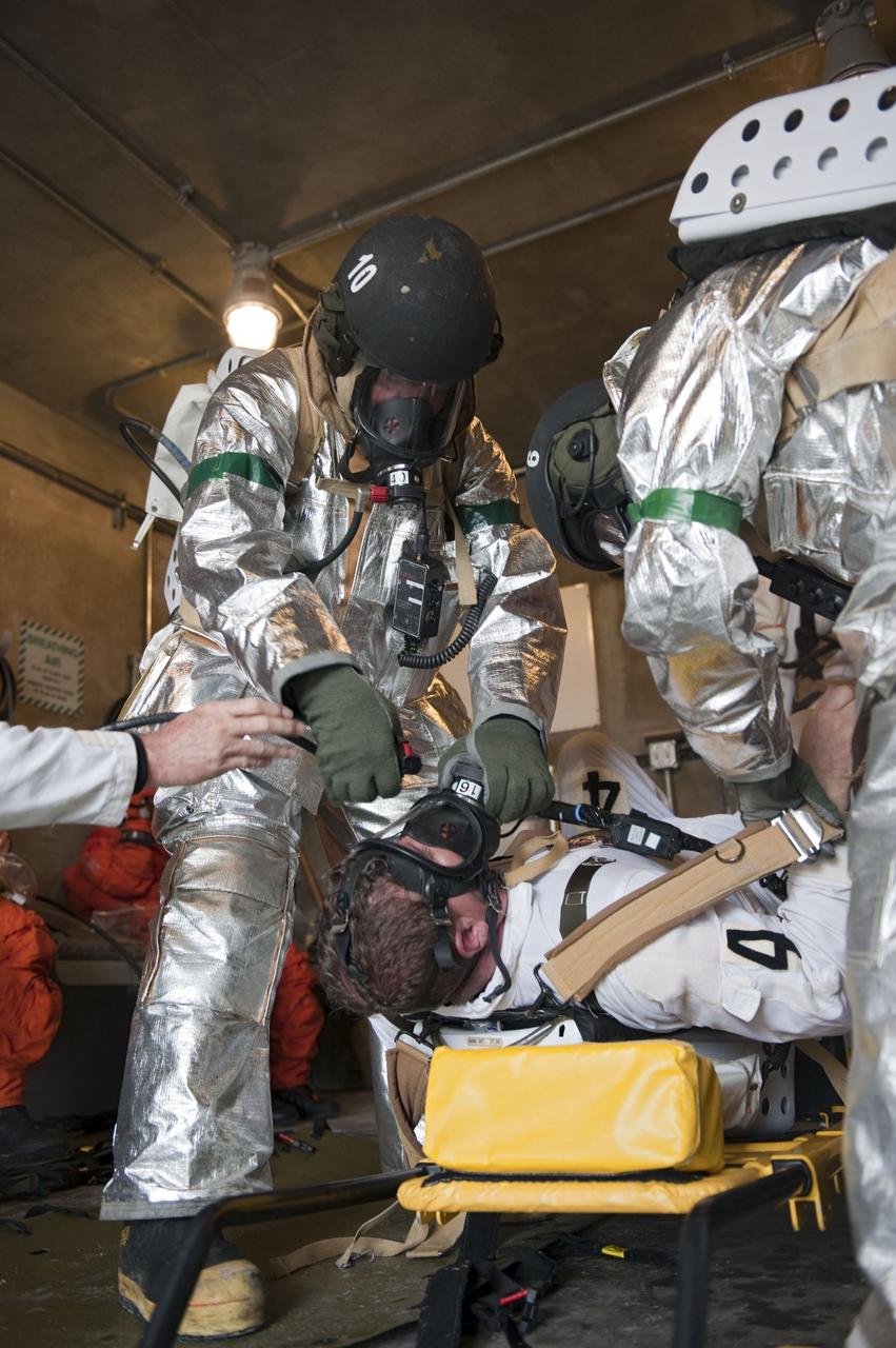 CAPE CANAVERAL, Fla. – An emergency exit, or Mode II/IV, exercise is under way in a bunker of Launch Pad 39A at NASA's Kennedy Space Center in Florida. The exercise involves NASA fire rescue personnel, volunteers portraying astronauts with simulated injuries, helicopters and personnel from the Air Force’s 920th Rescue Wing, and medical trauma teams at three Central Florida hospitals. The drill allows teams to practice an emergency response at the launch pad, including helicopter evacuation to local hospitals.           Photo credit: NASA/Kim Shiflett