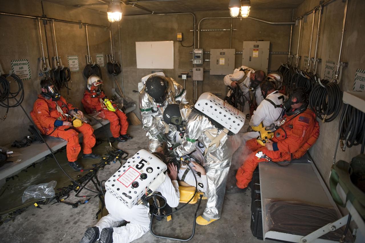 CAPE CANAVERAL, Fla. – An emergency exit, or Mode II/IV, exercise is under way in a bunker of Launch Pad 39A at NASA's Kennedy Space Center in Florida. The exercise involves NASA fire rescue personnel, volunteers portraying astronauts with simulated injuries, helicopters and personnel from the Air Force’s 920th Rescue Wing, and medical trauma teams at three Central Florida hospitals. The drill allows teams to practice an emergency response at the launch pad, including helicopter evacuation to local hospitals.         Photo credit: NASA/Kim Shiflett