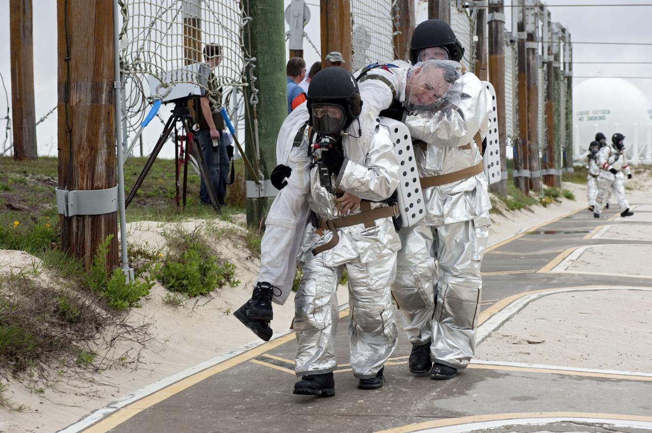 CAPE CANAVERAL, Fla. – An emergency exit, or Mode II/IV, exercise is under way at the slidewire basket landing site of Launch Pad 39A at NASA's Kennedy Space Center in Florida. The exercise involves NASA fire rescue personnel, volunteers portraying astronauts with simulated injuries, helicopters and personnel from the Air Force’s 920th Rescue Wing, and medical trauma teams at three Central Florida hospitals. The drill allows teams to practice an emergency response at the launch pad, including helicopter evacuation to local hospitals.       Photo credit: NASA/Kim Shiflett