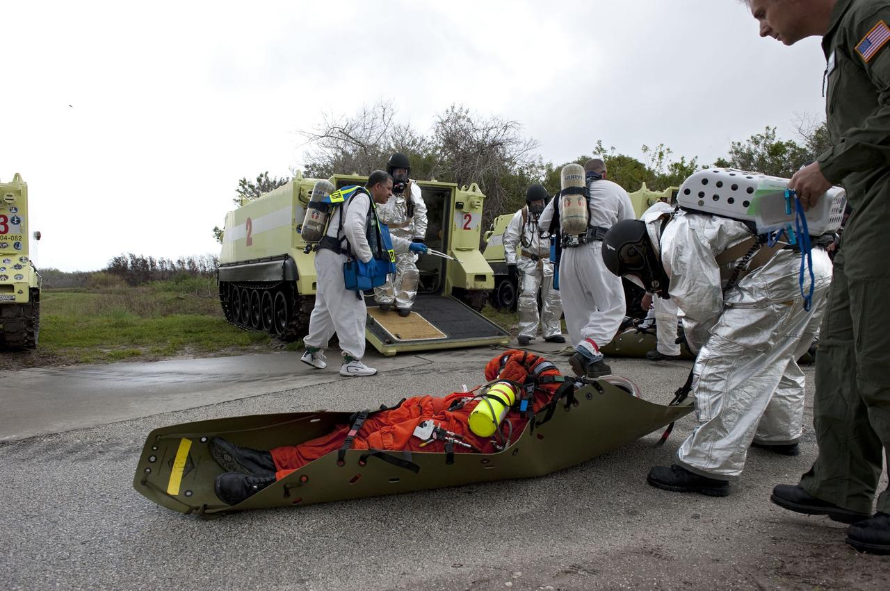 CAPE CANAVERAL, Fla. – An emergency exit, or Mode II/IV, exercise is under way near Launch Pad 39A at NASA's Kennedy Space Center in Florida. The exercise involves NASA fire rescue personnel, volunteers portraying astronauts with simulated injuries, helicopters and personnel from the Air Force’s 920th Rescue Wing, and medical trauma teams at three Central Florida hospitals. The drill allows teams to practice an emergency response at the launch pad, including helicopter evacuation to local hospitals.       Photo credit: NASA/Kim Shiflett