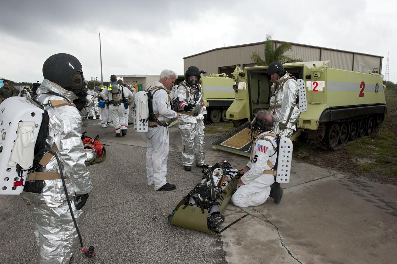 CAPE CANAVERAL, Fla. – An emergency exit, or Mode II/IV, exercise is under way near Launch Pad 39A at NASA's Kennedy Space Center in Florida. The exercise involves NASA fire rescue personnel, volunteers portraying astronauts with simulated injuries, helicopters and personnel from the Air Force’s 920th Rescue Wing, and medical trauma teams at three Central Florida hospitals. The drill allows teams to practice an emergency response at the launch pad, including helicopter evacuation to local hospitals.     Photo credit: NASA/Kim Shiflett