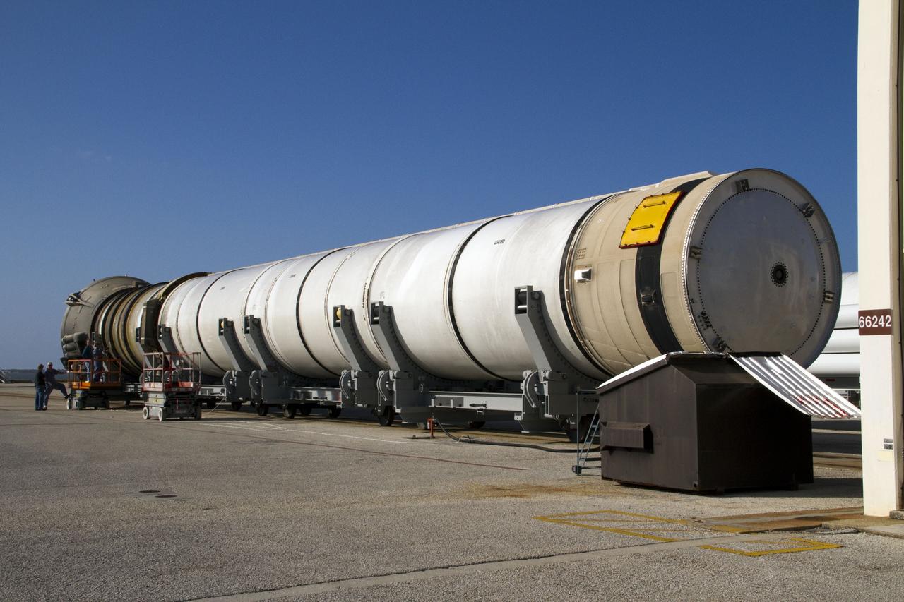 CAPE CANAVERAL, Fla. -- A spent shuttle solid rocket booster awaits inspection and cleaning near Hangar AF at Cape Canaveral Air Force Station in Florida. The booster was used during space shuttle Discovery's STS-133 launch from NASA Kennedy Space Center's Launch Pad 39A on Feb. 24. The shuttle’s two solid rocket booster casings and associated flight hardware were recovered in the Atlantic Ocean by retrieval ships Liberty Star and Freedom Star.      The boosters impact the Atlantic about seven minutes after liftoff and the retrieval ships are stationed about 10 miles from the impact area at the time of splashdown.  After the spent segments are processed, they will be transported to Utah, where they will be refurbished and stored, if needed. Photo credit: NASA/Jack Pfaller