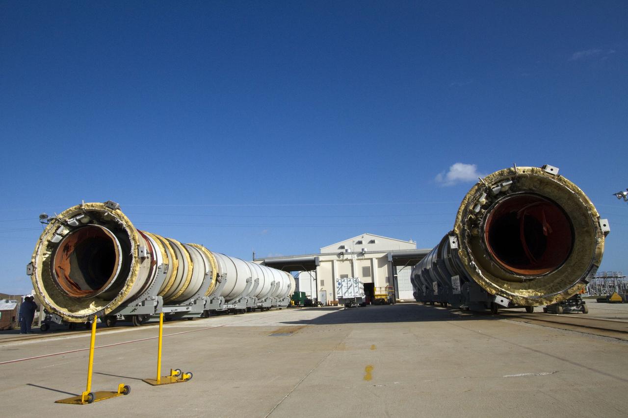 CAPE CANAVERAL, Fla. -- Two spent shuttle solid rocket boosters await inspection and cleaning near Hangar AF at Cape Canaveral Air Force Station in Florida. The boosters were used during space shuttle Discovery's STS-133 launch from NASA Kennedy Space Center's Launch Pad 39A on Feb. 24. The booster casings and associated flight hardware were recovered in the Atlantic Ocean by retrieval ships Liberty Star and Freedom Star. The boosters impact the Atlantic about seven minutes after liftoff and the retrieval ships are stationed about 10 miles from the impact area at the time of splashdown. After the spent segments are processed, they will be transported to Utah, where they will be refurbished and stored, if needed. Photo credit: NASA/Jack Pfaller
