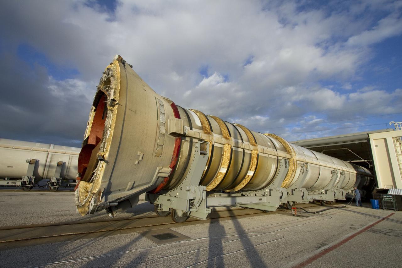 CAPE CANAVERAL, Fla. -- A spent shuttle solid rocket booster is moved into Hangar AF at Cape Canaveral Air Force Station in Florida, where it will be cleaned. The booster was used during space shuttle Discovery's STS-133 launch from NASA Kennedy Space Center's Launch Pad 39A on Feb. 24. The shuttle’s two solid rocket booster casings and associated flight hardware were recovered in the Atlantic Ocean by retrieval ships Liberty Star and Freedom Star.      The boosters impact the Atlantic about seven minutes after liftoff and the retrieval ships are stationed about 10 miles from the impact area at the time of splashdown.  After the spent segments are processed, they will be transported to Utah, where they will be refurbished and stored, if needed. Photo credit: NASA/Jack Pfaller