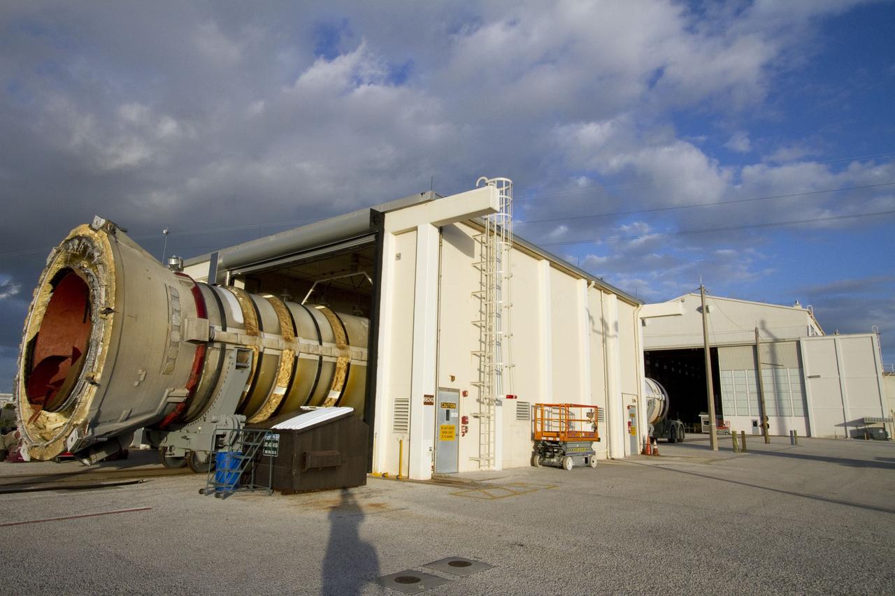CAPE CANAVERAL, Fla. -- A spent shuttle solid rocket booster is moved into Hangar AF at Cape Canaveral Air Force Station in Florida, where it will be cleaned. The booster was used during space shuttle Discovery's STS-133 launch from NASA Kennedy Space Center's Launch Pad 39A on Feb. 24. The shuttle’s two solid rocket booster casings and associated flight hardware were recovered in the Atlantic Ocean by retrieval ships Liberty Star and Freedom Star.    The boosters impact the Atlantic about seven minutes after liftoff and the retrieval ships are stationed about 10 miles from the impact area at the time of splashdown.  After the spent segments are processed, they will be transported to Utah, where they will be refurbished and stored, if needed. Photo credit: NASA/Jack Pfaller