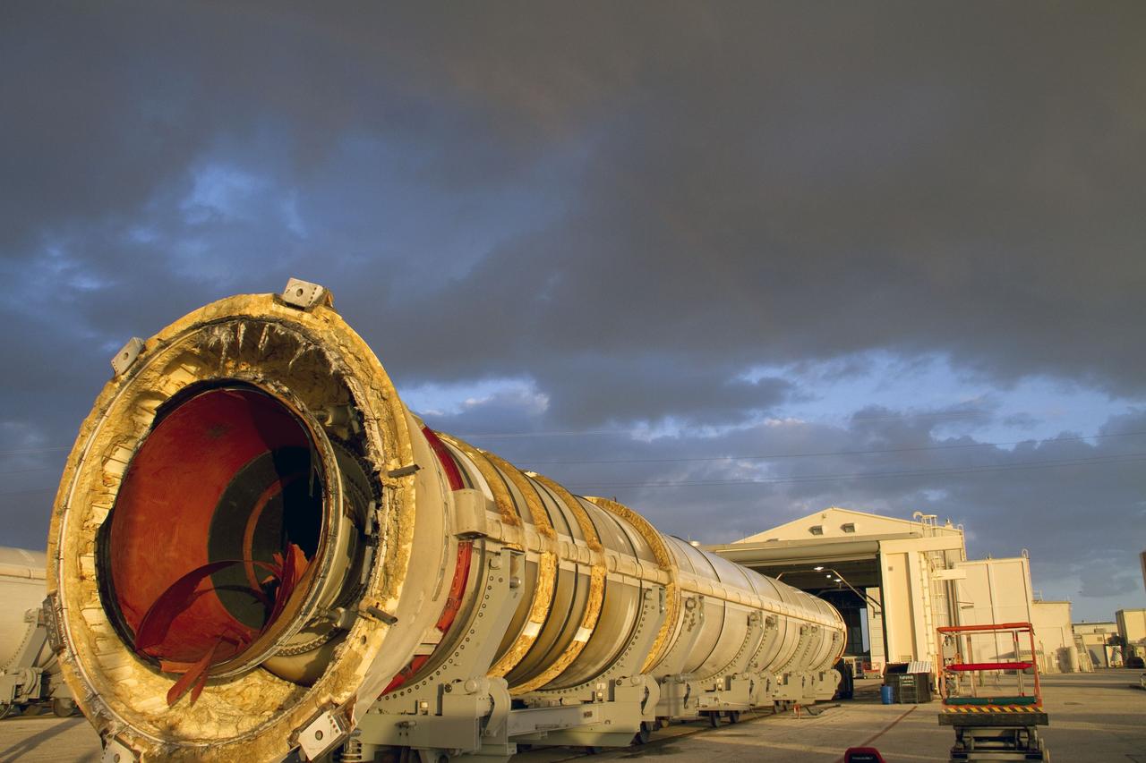 CAPE CANAVERAL, Fla. -- A spent shuttle solid rocket booster is moved into Hangar AF at Cape Canaveral Air Force Station in Florida, where it will be cleaned. The booster was used during space shuttle Discovery's STS-133 launch from NASA Kennedy Space Center's Launch Pad 39A on Feb. 24. The shuttle’s two solid rocket booster casings and associated flight hardware were recovered in the Atlantic Ocean by retrieval ships Liberty Star and Freedom Star.          The boosters impact the Atlantic about seven minutes after liftoff and the retrieval ships are stationed about 10 miles from the impact area at the time of splashdown.  After the spent segments are processed, they will be transported to Utah, where they will be refurbished and stored, if needed. Photo credit: NASA/Jack Pfaller