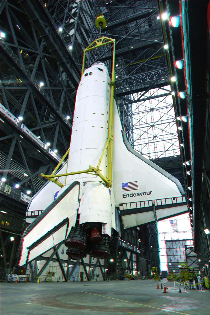 CAPE CANAVERAL, Fla. -- This is a 3-D image of space shuttle Endeavour as it is outfitted with a metal sling that will lift the spacecraft from the transfer aisle into a high bay of the Vehicle Assembly Building at NASA's Kennedy Space Center in Florida. In the bay, the shuttle will be attached to its external fuel tank and solid rocket boosters. Endeavour is targeted to roll out to Kennedy's Launch Pad 39A for its final mission, STS-134, on March 9. To view this image, use green and magenta 3-D glasses. Endeavour and six-member crew will deliver the Express Logistics Carrier-3, Alpha Magnetic Spectrometer-2 (AMS), a high-pressure gas tank, additional spare parts for the Dextre robotic helper and micrometeoroid debris shields to the International Space Station. Endeavour's final launch is targeted for April 19 at 7:48 p.m. EDT. For more information visit, http://www.nasa.gov/mission_pages/shuttle/shuttlemissions/sts134/index.html. Photo credit: NASA/Frankie Martin