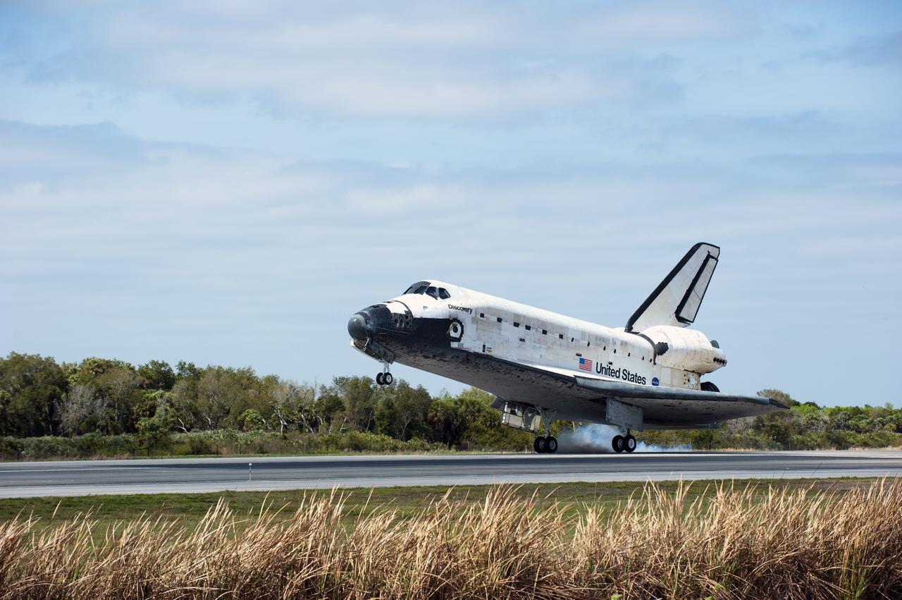 CAPE CANAVERAL, Fla. - Space shuttle Discovery touches down on Runway 15 at the Shuttle Landing Facility at NASA's Kennedy Space Center in Florida. Landing was at 11:57 a.m. EST, completing the 13-day STS-133 mission to the International Space Station. Main gear touchdown was at 11:57:17 a.m., followed by nose gear touchdown at 11:57:28, and wheelstop at 11:58:14 a.m. On board are Commander Steve Lindsey, Pilot Eric Boe, and Mission Specialists Nicole Stott, Michael Barratt, Alvin Drew and Steve Bowen.      Discovery and its six-member crew delivered the Permanent Multipurpose Module, packed with supplies and critical spare parts, as well as Robonaut 2, the dexterous humanoid astronaut helper, to the orbiting outpost. STS-133 was Discovery's 39th and final mission. This was the 133rd Space Shuttle Program mission and the 35th shuttle voyage to the space station. Photo credit: NASA/Kim Shiflett