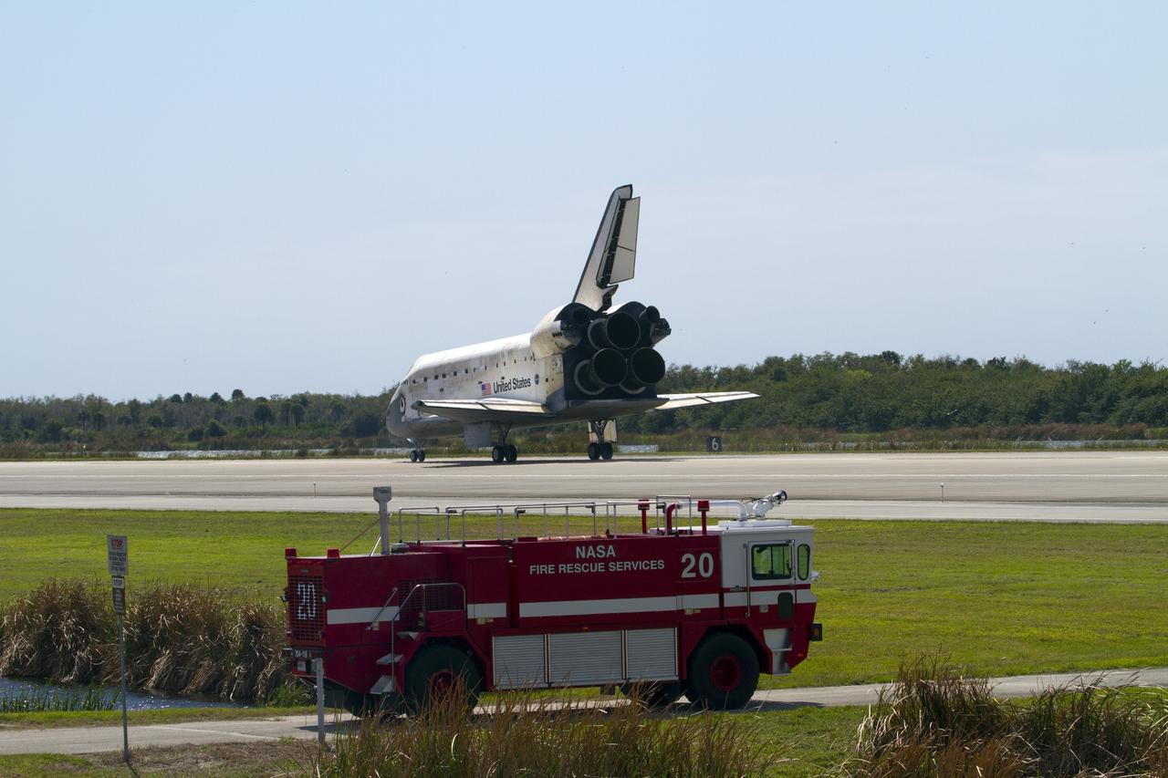CAPE CANAVERAL, Fla. - A NASA Fire Rescue Services vehicle drives toward space shuttle Discovery, which touched down on Runway 15 at the Shuttle Landing Facility at NASA's Kennedy Space Center in Florida. Landing was at 11:57 a.m. EST, completing the 13-day STS-133 mission to the International Space Station. Main gear touchdown was at 11:57:17 a.m., followed by nose gear touchdown at 11:57:28, and wheelstop at 11:58:14 a.m. On board are Commander Steve Lindsey, Pilot Eric Boe, and Mission Specialists Nicole Stott, Michael Barratt, Alvin Drew and Steve Bowen. Discovery and its six-member crew delivered the Permanent Multipurpose Module, packed with supplies and critical spare parts, as well as Robonaut 2, the dexterous humanoid astronaut helper, to the orbiting outpost. STS-133 was Discovery's 39th and final mission. This was the 133rd Space Shuttle Program mission and the 35th shuttle voyage to the space station. Photo credit: NASA/Jack Pfaller