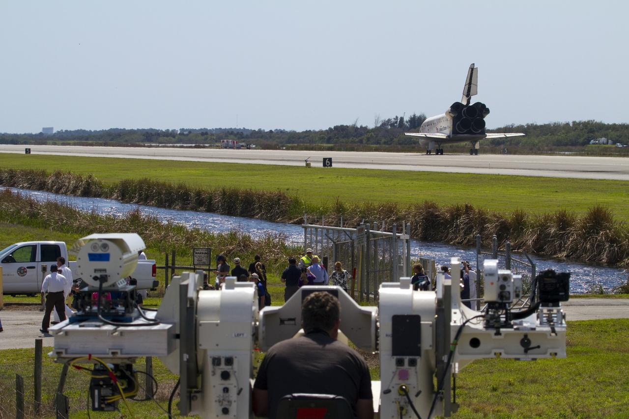 CAPE CANAVERAL, Fla. - NASA Kennedy Space Center workers watch as space shuttle Discovery rolls to a stop on Runway 15 at the Shuttle Landing Facility in Florida. Landing was at 11:57 a.m. EST, completing the 13-day STS-133 mission to the International Space Station. Main gear touchdown was at 11:57:17 a.m., followed by nose gear touchdown at 11:57:28, and wheelstop at 11:58:14 a.m. On board are Commander Steve Lindsey, Pilot Eric Boe, and Mission Specialists Nicole Stott, Michael Barratt, Alvin Drew and Steve Bowen. Discovery and its six-member crew delivered the Permanent Multipurpose Module, packed with supplies and critical spare parts, as well as Robonaut 2, the dexterous humanoid astronaut helper, to the orbiting outpost. STS-133 was Discovery's 39th and final mission. This was the 133rd Space Shuttle Program mission and the 35th shuttle voyage to the space station. Photo credit: NASA/Jack Pfaller