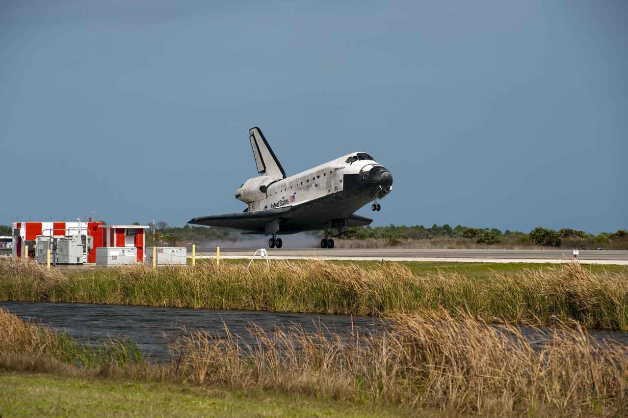 CAPE CANAVERAL, Fla. -- Space shuttle Discovery touches down on Runway 15 at the Shuttle Landing Facility at NASA's Kennedy Space Center in Florida. Landing was at 11:57 a.m. EST, completing the 13-day STS-133 mission to the International Space Station.         Main gear touchdown was at 11:57:17 a.m., followed by nose gear touchdown at 11:57:28, and wheelstop at 11:58:14 a.m. On board are Commander Steve Lindsey, Pilot Eric Boe, and Mission Specialists Nicole Stott, Michael Barratt, Alvin Drew and Steve Bowen. Discovery and its six-member crew delivered the Permanent Multipurpose Module, packed with supplies and critical spare parts, as well as Robonaut 2, the dexterous humanoid astronaut helper, to the orbiting outpost. STS-133 was Discovery's 39th and final mission. This was the 133rd Space Shuttle Program mission and the 35th shuttle voyage to the space station. Photo credit: NASA/Chuck Tintera