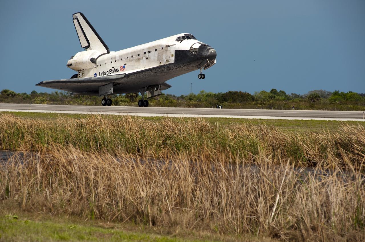 CAPE CANAVERAL, Fla. -- Space shuttle Discovery touches down on Runway 15 at the Shuttle Landing Facility at NASA's Kennedy Space Center in Florida. Landing was at 11:57 a.m. EST, completing the 13-day STS-133 mission to the International Space Station.         Main gear touchdown was at 11:57:17 a.m., followed by nose gear touchdown at 11:57:28, and wheelstop at 11:58:14 a.m. On board are Commander Steve Lindsey, Pilot Eric Boe, and Mission Specialists Nicole Stott, Michael Barratt, Alvin Drew and Steve Bowen. Discovery and its six-member crew delivered the Permanent Multipurpose Module, packed with supplies and critical spare parts, as well as Robonaut 2, the dexterous humanoid astronaut helper, to the orbiting outpost. STS-133 was Discovery's 39th and final mission. This was the 133rd Space Shuttle Program mission and the 35th shuttle voyage to the space station. Photo credit: NASA/Chuck Tintera