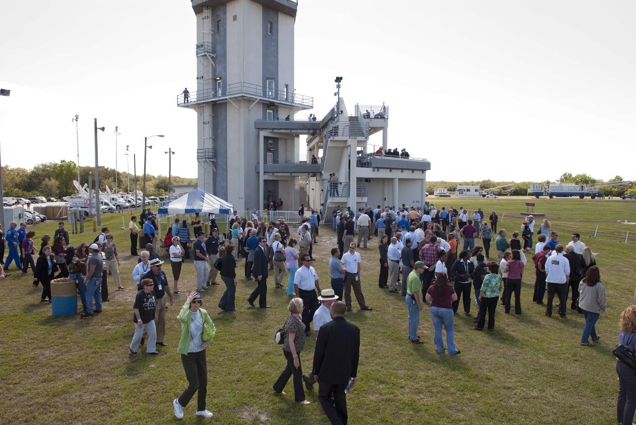 CAPE CANAVERAL, Fla. -- At NASA's Kennedy Space Center in Florida, invited guests, managers and employees gather near the Air Traffic Control Tower at the Shuttle Landing Facility (SLF) to watch shuttle Discovery return from space for the last time. Discovery touched down on Runway 15 at 11:57 a.m. EST, completing the 13-day STS-133 mission to the International Space Station.                Discovery and its six-member crew delivered the Permanent Multipurpose Module, packed with supplies and critical spare parts, as well as Robonaut 2, the dexterous humanoid astronaut helper, to the orbiting outpost. STS-133 was Discovery's 39th and final mission. This was the 133rd Space Shuttle Program mission and the 35th shuttle voyage to the space station. Photo credit: NASA/Jim Grossmann