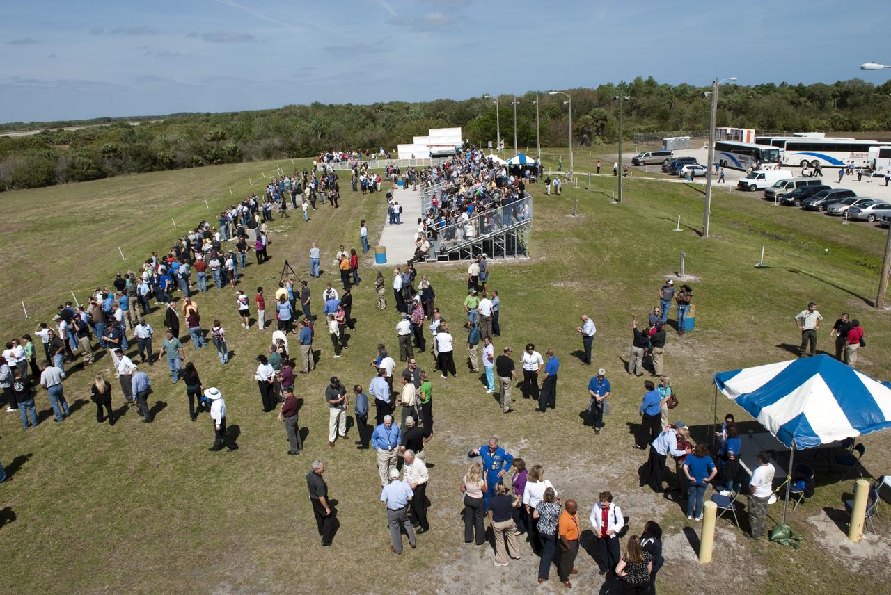 CAPE CANAVERAL, Fla. -- At NASA's Kennedy Space Center in Florida, invited guests, managers and employees gather near the Air Traffic Control Tower at the Shuttle Landing Facility (SLF) to watch shuttle Discovery return from space for the last time. Discovery touched down on Runway 15 at 11:57 a.m. EST, completing the 13-day STS-133 mission to the International Space Station. Discovery and its six-member crew delivered the Permanent Multipurpose Module, packed with supplies and critical spare parts, as well as Robonaut 2, the dexterous humanoid astronaut helper, to the orbiting outpost. STS-133 was Discovery's 39th and final mission. This was the 133rd Space Shuttle Program mission and the 35th shuttle voyage to the space station. Photo credit: NASA/Jim Grossmann
