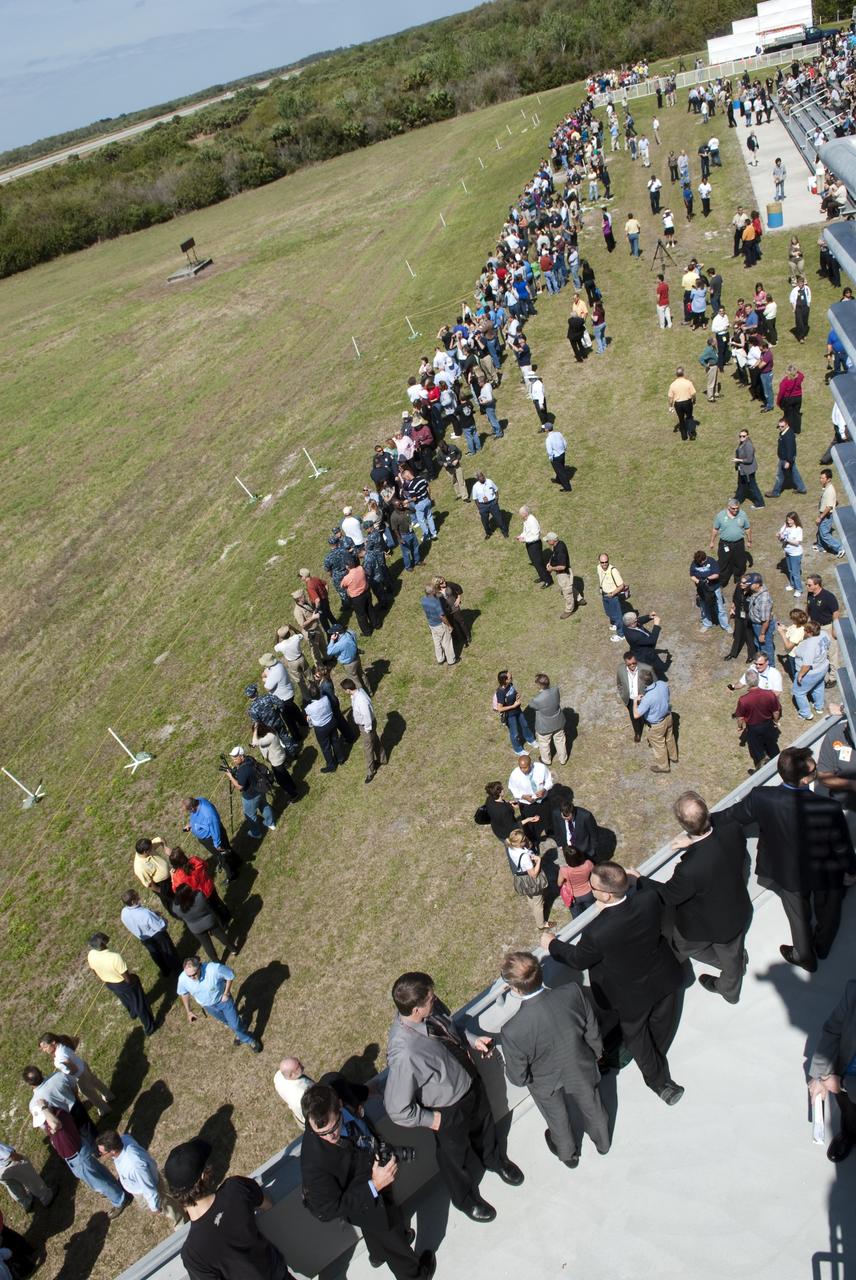 CAPE CANAVERAL, Fla. -- At NASA's Kennedy Space Center in Florida, invited guests, managers and employees gather near the Air Traffic Control Tower at the Shuttle Landing Facility (SLF) to watch shuttle Discovery return from space for the last time. Discovery touched down on Runway 15 at 11:57 a.m. EST, completing the 13-day STS-133 mission to the International Space Station. Discovery and its six-member crew delivered the Permanent Multipurpose Module, packed with supplies and critical spare parts, as well as Robonaut 2, the dexterous humanoid astronaut helper, to the orbiting outpost. STS-133 was Discovery's 39th and final mission. This was the 133rd Space Shuttle Program mission and the 35th shuttle voyage to the space station. Photo credit: NASA/Jim Grossmann
