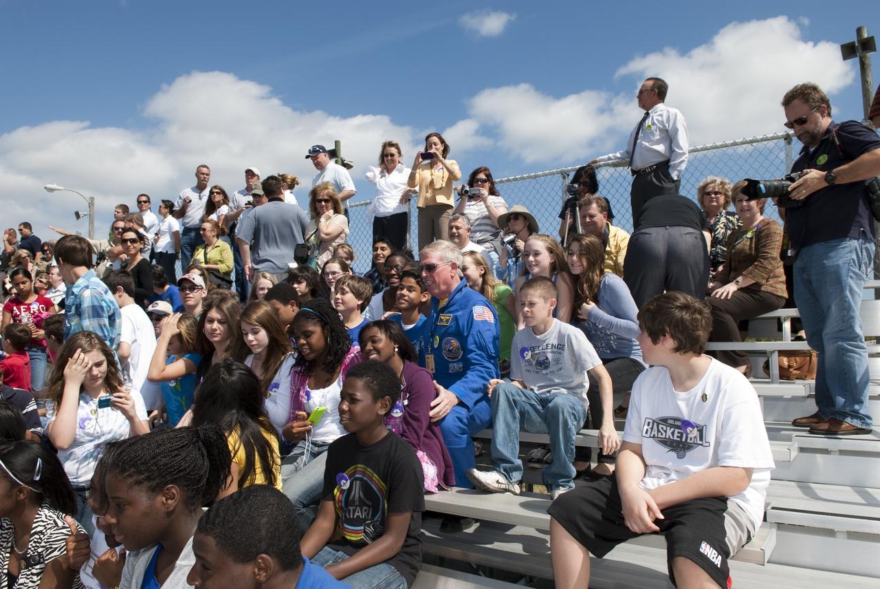 CAPE CANAVERAL, Fla. -- At NASA's Kennedy Space Center in Florida, retired NASA astronaut Jon McBride mingles with about 50 eighth-grade students from McNair Magnet Middle School in Rockledge, Fla., and other invited guests who are at the Shuttle Landing Facility (SLF) to watch shuttle Discovery return from space for the last time. Discovery touched down on Runway 15 at 11:57 a.m. EST, completing the 13-day STS-133 mission to the International Space Station.                Discovery and its six-member crew delivered the Permanent Multipurpose Module, packed with supplies and critical spare parts, as well as Robonaut 2, the dexterous humanoid astronaut helper, to the orbiting outpost. STS-133 was Discovery's 39th and final mission. This was the 133rd Space Shuttle Program mission and the 35th shuttle voyage to the space station. Photo credit: NASA/Jim Grossmann