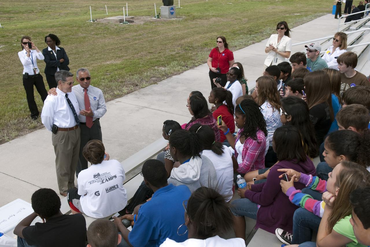 CAPE CANAVERAL, Fla. -- NASA Kennedy Space Center Director Bob Cabana, left, and NASA Administrator Charlie Bolden talk to about 50 eighth-grade students from McNair Magnet Middle School in Rockledge, Fla., and other invited guests who are at the center to watch shuttle Discovery return from space for the last time. Discovery touched down on Shuttle Landing Facility's Runway 15 at 11:57 a.m. EST, completing the 13-day STS-133 mission to the International Space Station. Discovery and its six-member crew delivered the Permanent Multipurpose Module, packed with supplies and critical spare parts, as well as Robonaut 2, the dexterous humanoid astronaut helper, to the orbiting outpost. STS-133 was Discovery's 39th and final mission. This was the 133rd Space Shuttle Program mission and the 35th shuttle voyage to the space station. Photo credit: NASA/Jim Grossmann
