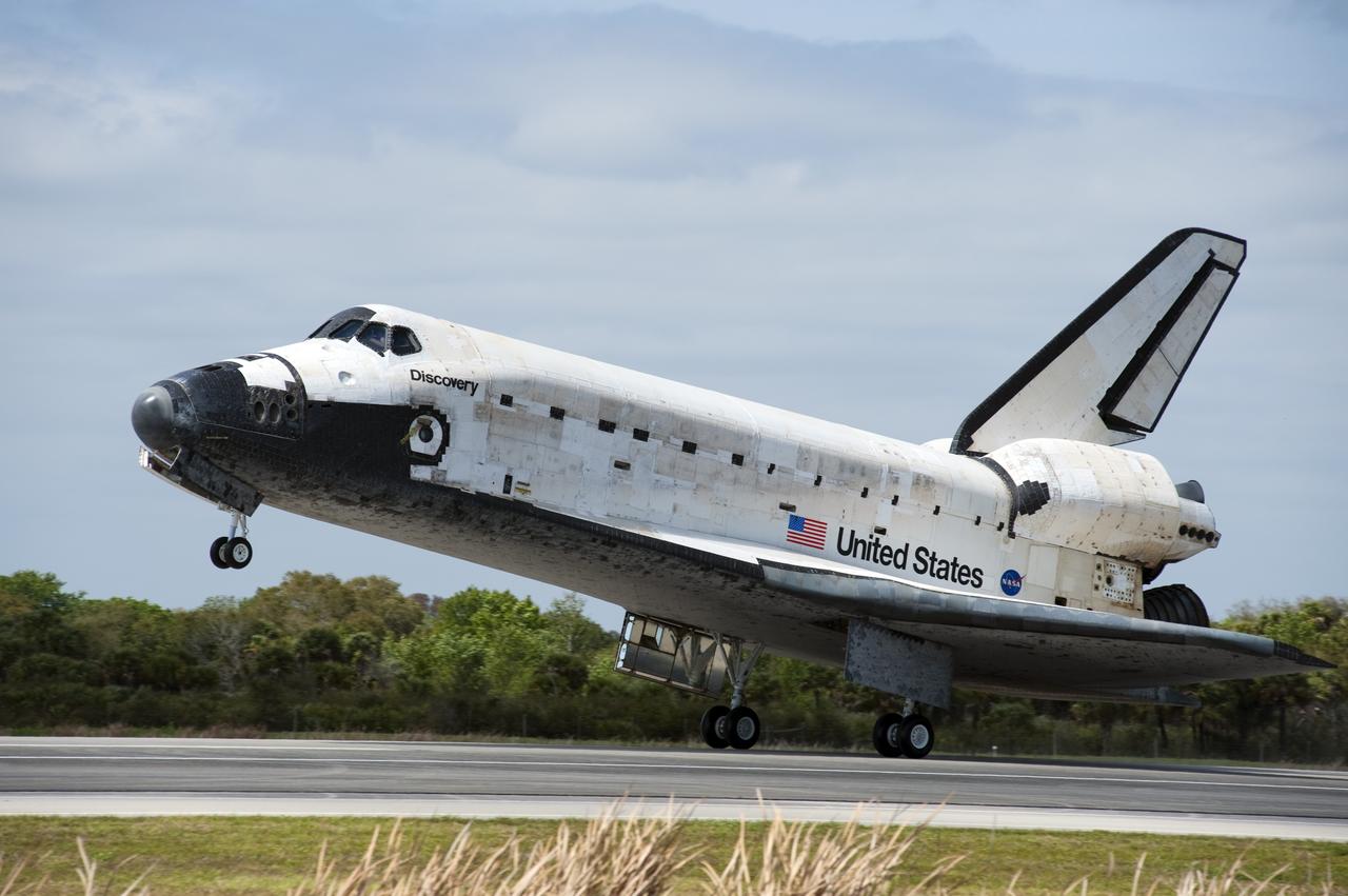 CAPE CANAVERAL, Fla. - Space shuttle Discovery's main landing gear touches down on Runway 15 at the Shuttle Landing Facility at NASA's Kennedy Space Center in Florida after 13-days in space, completing the 5.3-million-mile STS-133 mission. Main gear touchdown was at 11:57:17 a.m., followed by nose gear touchdown at 11:57:28, and wheelstop at 11:58:14 a.m. On board are Commander Steve Lindsey, Pilot Eric Boe, and Mission Specialists Nicole Stott, Michael Barratt, Alvin Drew and Steve Bowen.            Discovery and its six-member crew delivered the Permanent Multipurpose Module, packed with supplies and critical spare parts, as well as Robonaut 2, the dexterous humanoid astronaut helper, to the orbiting outpost. STS-133 was Discovery's 39th and final mission. This was the 133rd Space Shuttle Program mission and the 35th shuttle voyage to the space station. Photo credit: NASA/Linda Perry