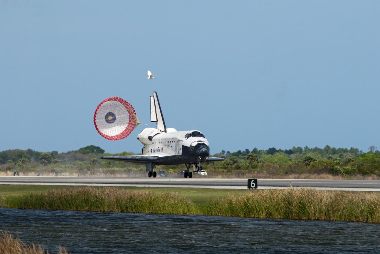 CAPE CANAVERAL, Fla. - Space shuttle Discovery's drag chute deploys on Runway 15 at the Shuttle Landing Facility at NASA's Kennedy Space Center in Florida. Discovery's final return from space completed the 13-day, 5.3-million-mile STS-133 mission. Main gear touchdown was at 11:57:17 a.m., followed by nose gear touchdown at 11:57:28, and wheelstop at 11:58:14 a.m. On board are Commander Steve Lindsey, Pilot Eric Boe, and Mission Specialists Nicole Stott, Michael Barratt, Alvin Drew and Steve Bowen. Discovery and its six-member crew delivered the Permanent Multipurpose Module, packed with supplies and critical spare parts, as well as Robonaut 2, the dexterous humanoid astronaut helper, to the orbiting outpost. STS-133 was Discovery's 39th and final mission. This was the 133rd Space Shuttle Program mission and the 35th shuttle voyage to the space station. Photo credit: NASA/Tim Powers
