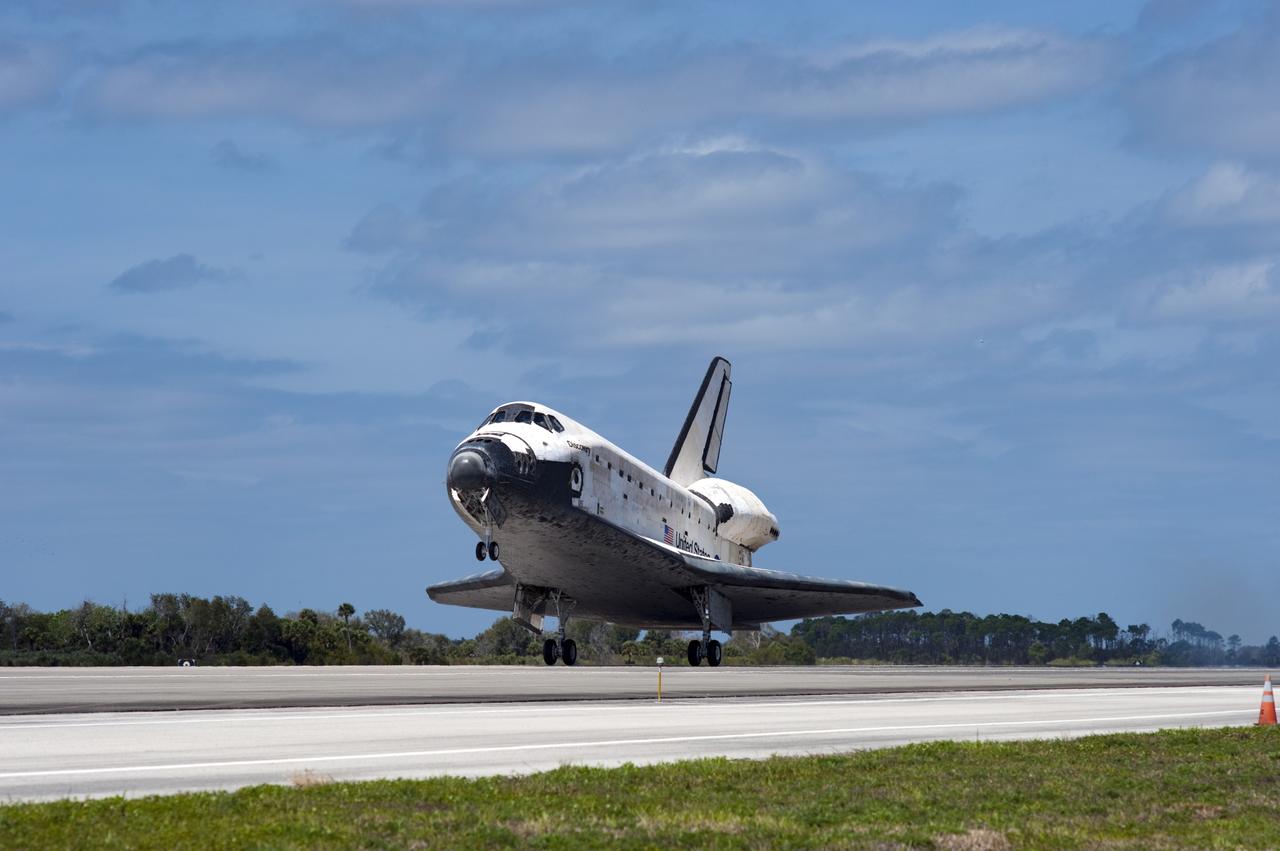 CAPE CANAVERAL, Fla. -- The nose gear on space shuttle Discovery descends in anticipation of touch down on Runway 15 at the Shuttle Landing Facility at NASA's Kennedy Space Center in Florida. Discovery's final return from space completed the 13-day, 5.3-million-mile STS-133 mission. Main gear touchdown was at 11:57:17 a.m., followed by nose gear touchdown at 11:57:28, and wheelstop at 11:58:14 a.m. On board are Commander Steve Lindsey, Pilot Eric Boe, and Mission Specialists Nicole Stott, Michael Barratt, Alvin Drew and Steve Bowen. Discovery and its six-member crew delivered the Permanent Multipurpose Module, packed with supplies and critical spare parts, as well as Robonaut 2, the dexterous humanoid astronaut helper, to the orbiting outpost. STS-133 was Discovery's 39th and final mission. This was the 133rd Space Shuttle Program mission and the 35th shuttle voyage to the space station. Photo credit: NASA/Sandra Joseph and Kevin O'Connell