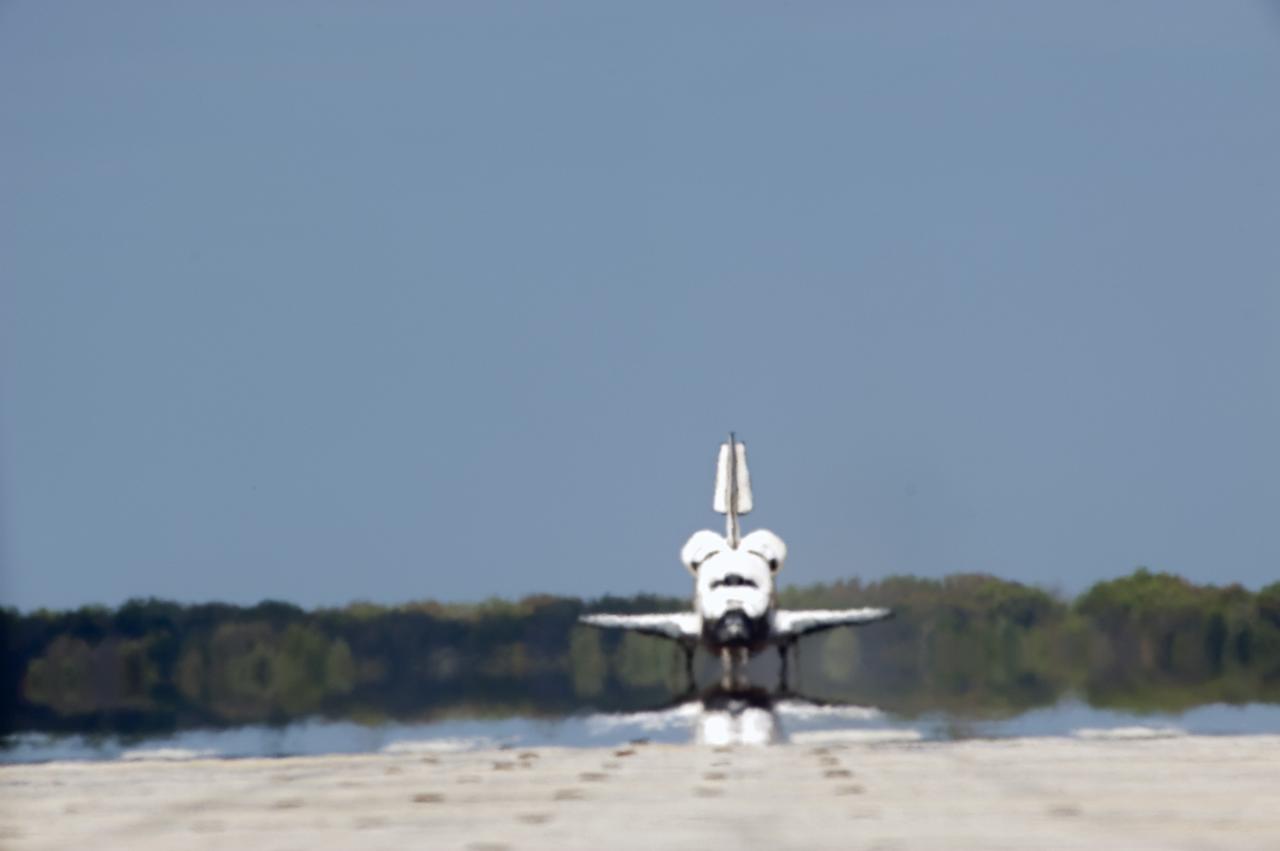 CAPE CANAVERAL, Fla. - Space shuttle Discovery appears to be a mirage as it makes its way down Runway 15 at the Shuttle Landing Facility at NASA's Kennedy Space Center in Florida. Discovery's final return from space completed the 13-day, 5.3-million-mile STS-133 mission. Main gear touchdown was at 11:57:17 a.m., followed by nose gear touchdown at 11:57:28, and wheelstop at 11:58:14 a.m. On board are Commander Steve Lindsey, Pilot Eric Boe, and Mission Specialists Nicole Stott, Michael Barratt, Alvin Drew and Steve Bowen. Discovery and its six-member crew delivered the Permanent Multipurpose Module, packed with supplies and critical spare parts, as well as Robonaut 2, the dexterous humanoid astronaut helper, to the orbiting outpost. STS-133 was Discovery's 39th and final mission. This was the 133rd Space Shuttle Program mission and the 35th shuttle voyage to the space station. Photo credit: NASA/Tony Gray and Tom Farrar