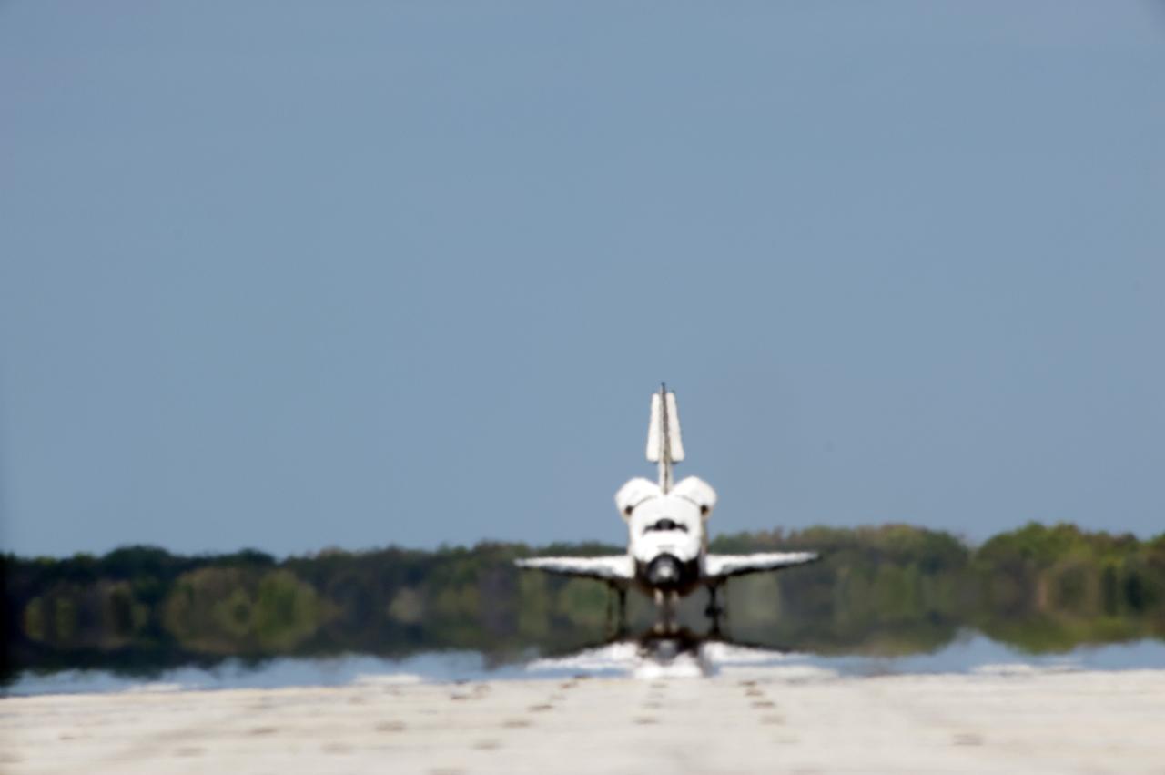 CAPE CANAVERAL, Fla. - Space shuttle Discovery appears to be a mirage as it coasts down Runway 15 at the Shuttle Landing Facility at NASA's Kennedy Space Center in Florida. Discovery's final return from space completed the 13-day, 5.3-million-mile STS-133 mission. Main gear touchdown was at 11:57:17 a.m., followed by nose gear touchdown at 11:57:28, and wheelstop at 11:58:14 a.m. On board are Commander Steve Lindsey, Pilot Eric Boe, and Mission Specialists Nicole Stott, Michael Barratt, Alvin Drew and Steve Bowen. Discovery and its six-member crew delivered the Permanent Multipurpose Module, packed with supplies and critical spare parts, as well as Robonaut 2, the dexterous humanoid astronaut helper, to the orbiting outpost. STS-133 was Discovery's 39th and final mission. This was the 133rd Space Shuttle Program mission and the 35th shuttle voyage to the space station. Photo credit: NASA/Tony Gray and Tom Farrar