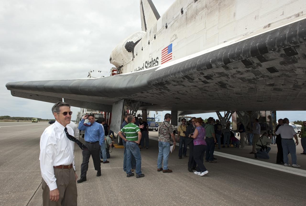 CAPE CANAVERAL, Fla. -- Bob Cabana, director of NASA's Kennedy Space Center in Florida, walks around space shuttle Discovery, following its final return from space. Touchdown on the Shuttle Landing Facility's Runway 15 was at 11:57 a.m. EST, bringing an end to the 13-day STS-133 mission to the International Space Station.    Discovery and its six-member crew delivered the Permanent Multipurpose Module, packed with supplies and critical spare parts, as well as Robonaut 2, the dexterous humanoid astronaut helper, to the orbiting outpost. STS-133 was Discovery's 39th and final mission. This was the 133rd Space Shuttle Program mission and the 35th shuttle voyage to the space station. Photo credit: NASA/Kim Shiflett
