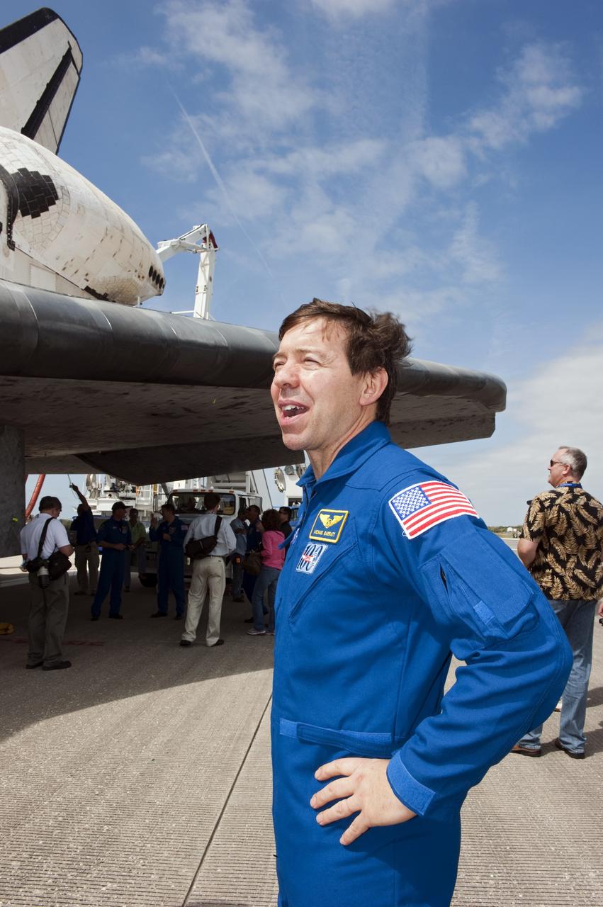 CAPE CANAVERAL, Fla. -- STS-133 Mission Specialist Michael Barratt admires space shuttle Discovery on the Shuttle Landing Facility's Runway 15 at NASA's Kennedy Space Center in Florida. Barratt and his crewmates returned from a 13-day, 5.3-million-mile mission to the International Space Station at 11:57 a.m. EST.    STS-133 delivered the Permanent Multipurpose Module, packed with supplies and critical spare parts, as well as Robonaut 2, the dexterous humanoid astronaut helper, to the orbiting outpost. STS-133 was Discovery's 39th and final mission. This was the 133rd Space Shuttle Program mission and the 35th shuttle voyage to the space station. Photo credit: NASA/Kim Shiflett