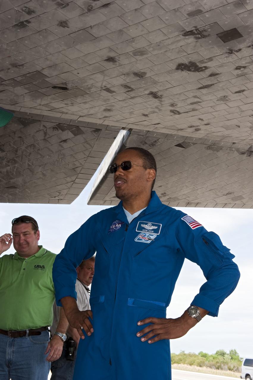 CAPE CANAVERAL, Fla. -- STS-133 Mission Specialist Alvin Drew admires space shuttle Discovery on the Shuttle Landing Facility's Runway 15 at NASA's Kennedy Space Center in Florida. Drew and his crewmates returned from a 13-day, 5.3-million-mile mission to the International Space Station at 11:57 a.m. EST.    STS-133 delivered the Permanent Multipurpose Module, packed with supplies and critical spare parts, as well as Robonaut 2, the dexterous humanoid astronaut helper, to the orbiting outpost. STS-133 was Discovery's 39th and final mission. This was the 133rd Space Shuttle Program mission and the 35th shuttle voyage to the space station. Photo credit: NASA/Kim Shiflett