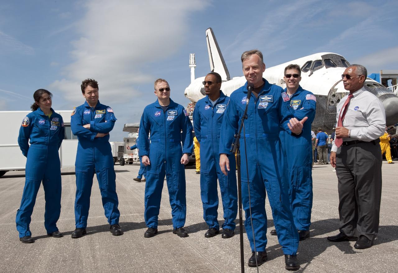 CAPE CANAVERAL, Fla. -- On the Shuttle Landing Facility at NASA's Kennedy Space Center in Florida, STS-133 Commander Steve Lindsey talks to media representatives about space shuttle Discovery's final spaceflight mission. Behind Lindsey, from left, are Mission Specialists Nicole Stott and Michael Barratt, Pilot Eric Boe, Mission Specialists Alvin Drew and Steve Bowen, and NASA Administrator Charlie Bolden. The STS-133 crew returned to Earth at 11:57 a.m. on Runway 15, completing a 13-day, 5.3-million-mile mission to the International Space Station.    STS-133 delivered the Permanent Multipurpose Module, packed with supplies and critical spare parts, as well as Robonaut 2, the dexterous humanoid astronaut helper, to the orbiting outpost. STS-133 was Discovery's 39th and final mission. This was the 133rd Space Shuttle Program mission and the 35th shuttle voyage to the space station. Photo credit: NASA/Kim Shiflett