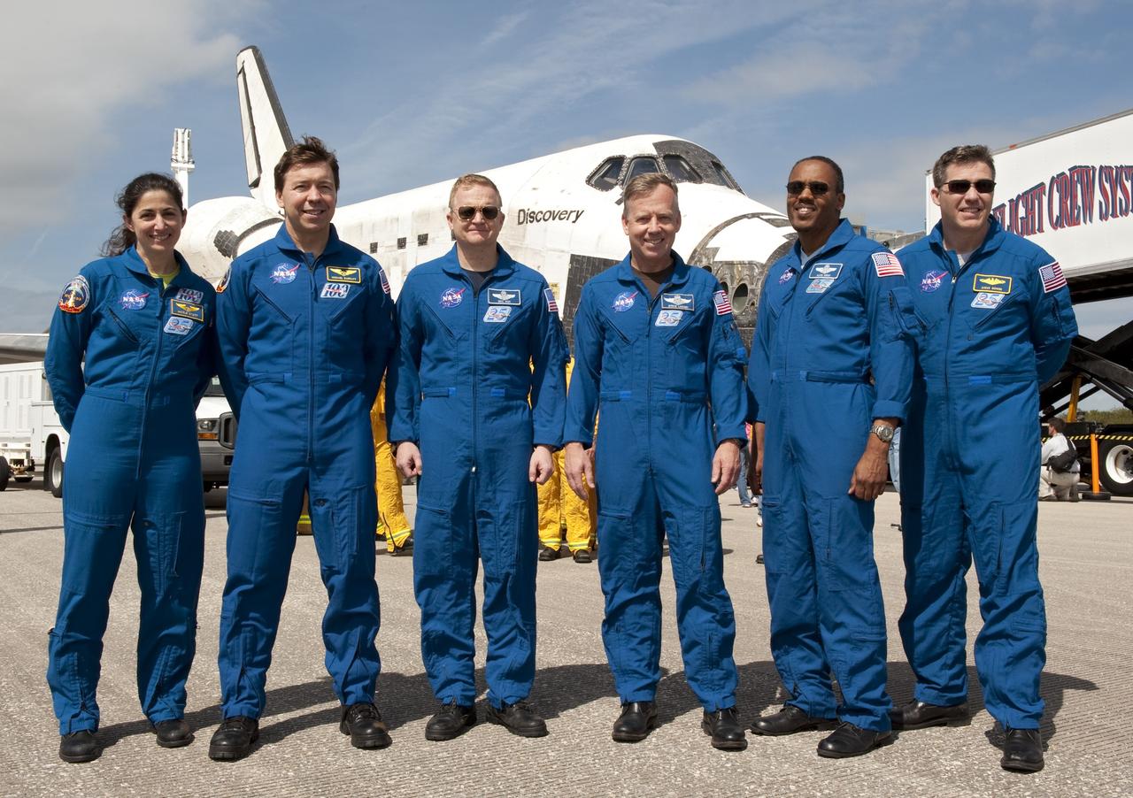 CAPE CANAVERAL, Fla. -- The STS-133 crew poses for a photo in front of space shuttle Discovery on the Shuttle Landing Facility's Runway 15 at NASA's Kennedy Space Center in Florida. From left, are Mission Specialists Nicole Stott and Michael Barratt, Pilot Eric Boe, Commander Steve Lindsey, and Mission Specialists Alvin Drew and Steve Bowen. Discovery and crew returned to Earth at 11:57 a.m., completing a 13-day, 5.3-million-mile mission to the International Space Station.    STS-133 delivered the Permanent Multipurpose Module, packed with supplies and critical spare parts, as well as Robonaut 2, the dexterous humanoid astronaut helper, to the orbiting outpost. STS-133 was Discovery's 39th and final mission. This was the 133rd Space Shuttle Program mission and the 35th shuttle voyage to the space station. Photo credit: NASA/Kim Shiflett