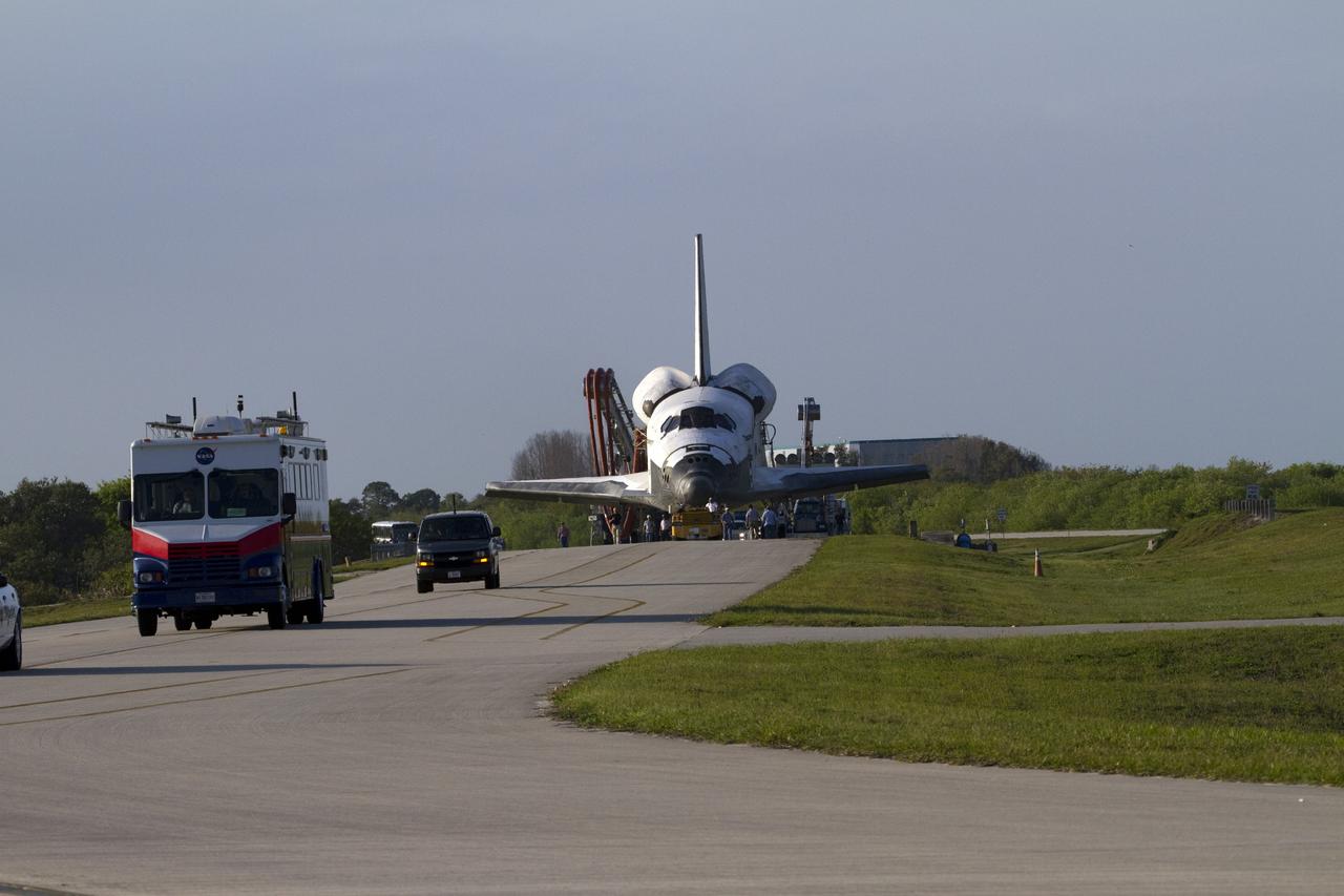 CAPE CANAVERAL, Fla. - The Convoy Command Vehicle leads space shuttle Discovery and the landing convoy along the towway from the Shuttle Landing Facility to Orbiter Processing Facility-2 at NASA's Kennedy Space Center in Florida. Discovery touched down on Runway 15 at 11:57 a.m., bringing an end to its 39th and final spaceflight mission, STS-133. Discovery and its six-member STS-133 crew delivered the Permanent Multipurpose Module, packed with supplies and critical spare parts, as well as Robonaut 2, the dexterous humanoid astronaut helper, to the International Space Station.    Inside the processing facility, Discovery will be prepared for future public display.  Photo credit: NASA/Jack Pfaller