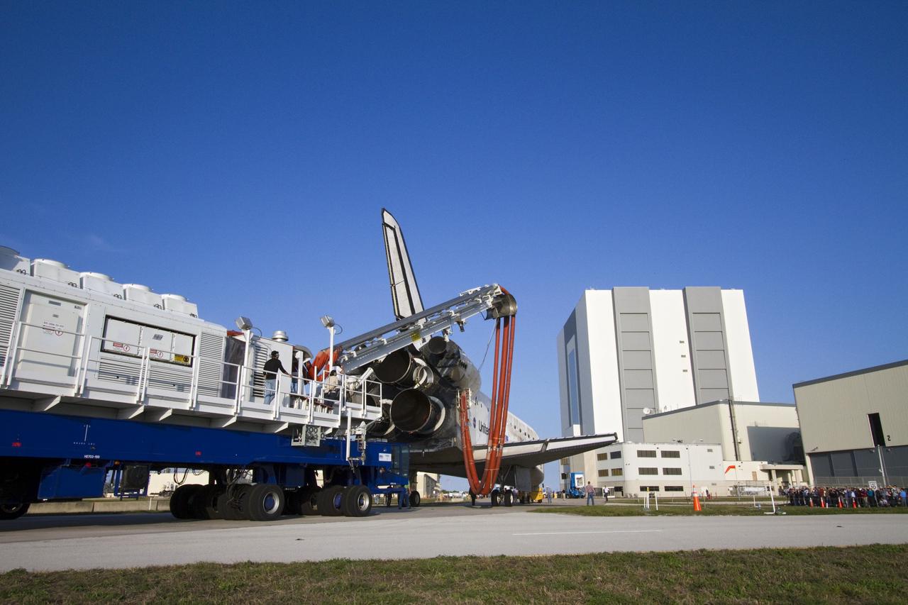 CAPE CANAVERAL, Fla. - Space shuttle Discovery, attached to a purge unit that pumps conditioned air into the shuttle while it is towed, approaches Orbiter Processing Facility-2 at NASA's Kennedy Space Center in Florida.  Behind the processing bays is the 525-foot-tall Vehicle Assembly Building.  Discovery touched down on the Shuttle Landing Facility's Runway 15 at 11:57 a.m., bringing an end to its 39th and final spaceflight mission, STS-133. Discovery and its six-member STS-133 crew delivered the Permanent Multipurpose Module, packed with supplies and critical spare parts, as well as Robonaut 2, the dexterous humanoid astronaut helper, to the International Space Station.    Inside the processing facility, Discovery will be prepared for future public display.  Photo credit: NASA/Jack Pfaller