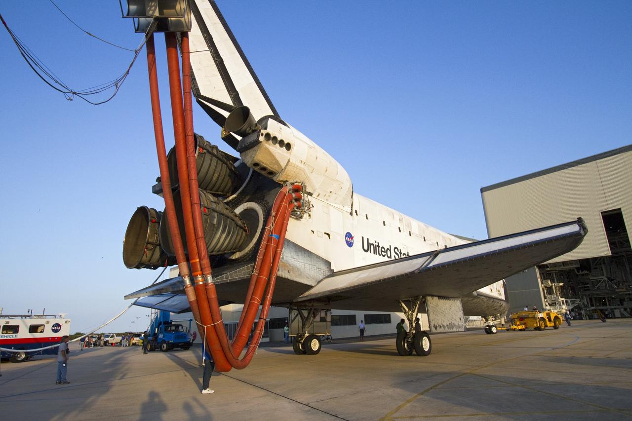 CAPE CANAVERAL, Fla. - Space shuttle Discovery is towed into position for entry through the door of Orbiter Processing Facility-2 at NASA's Kennedy Space Center in Florida. Discovery is attached to a purge unit that pumps conditioned air into the shuttle while it is towed. Discovery touched down on the Shuttle Landing Facility's Runway 15 at 11:57 a.m., bringing an end to its 39th and final spaceflight mission, STS-133. Discovery and its six-member STS-133 crew delivered the Permanent Multipurpose Module, packed with supplies and critical spare parts, as well as Robonaut 2, the dexterous humanoid astronaut helper, to the International Space Station. Inside the processing facility, Discovery will be prepared for future public display. Photo credit: NASA/Jack Pfaller