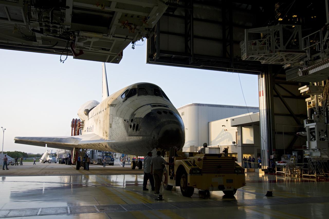 CAPE CANAVERAL, Fla. - Space shuttle Discovery's "towback" vehicle slowly pulls the spacecraft into Orbiter Processing Facility-2 at NASA's Kennedy Space Center in Florida. Discovery touched down on the Shuttle Landing Facility's Runway 15 at 11:57 a.m., bringing an end to its 39th and final spaceflight mission, STS-133. Discovery and its six-member STS-133 crew delivered the Permanent Multipurpose Module, packed with supplies and critical spare parts, as well as Robonaut 2, the dexterous humanoid astronaut helper, to the International Space Station.           Inside the processing facility, Discovery will be prepared for future public display.  Photo credit: NASA/Jack Pfaller