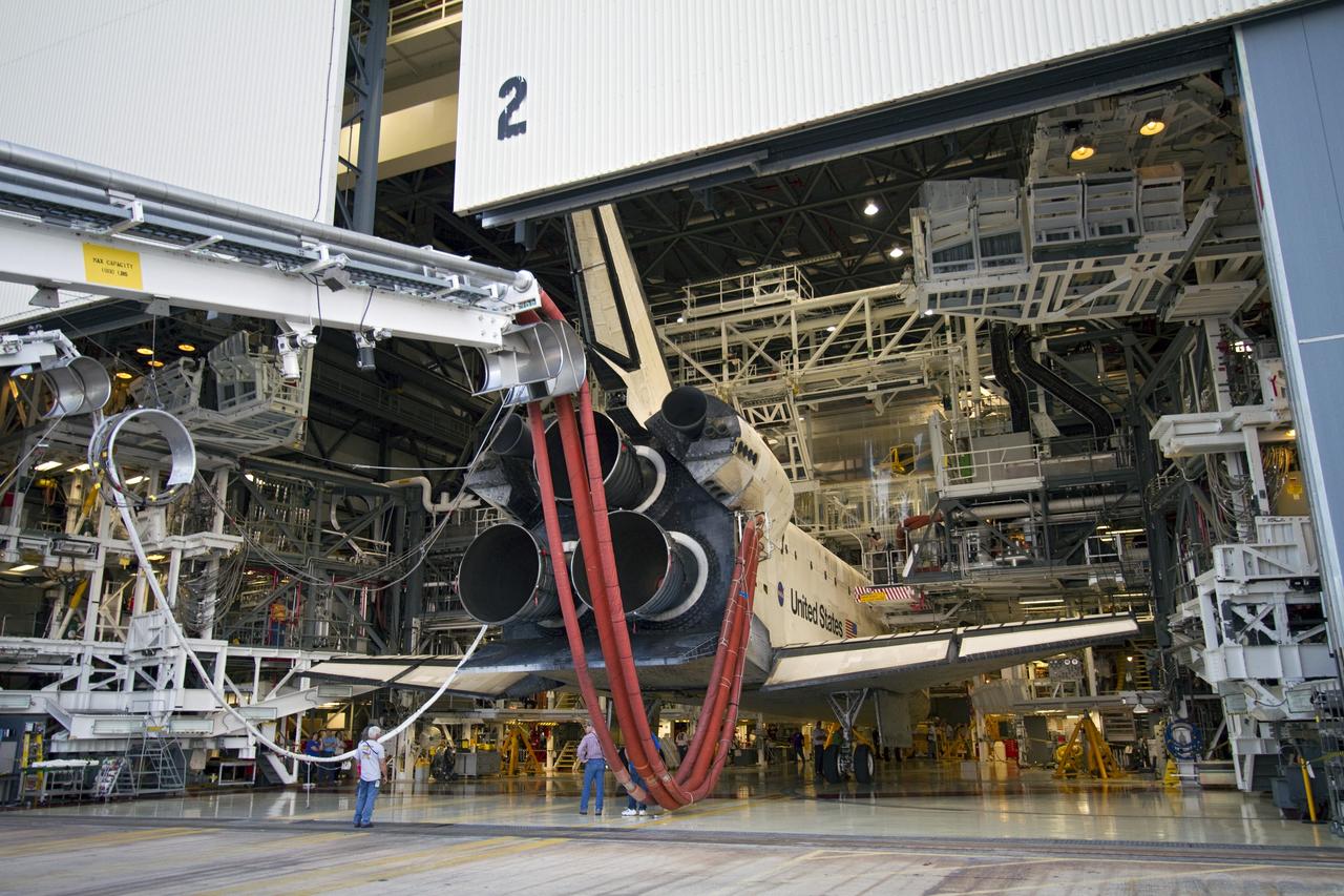 CAPE CANAVERAL, Fla. - Space shuttle Discovery enters Orbiter Processing Facility-2 at NASA's Kennedy Space Center in Florida during a move called "towback." Discovery touched down on the Shuttle Landing Facility's Runway 15 at 11:57 a.m., bringing an end to its 39th and final spaceflight mission, STS-133. Discovery and its six-member STS-133 crew delivered the Permanent Multipurpose Module, packed with supplies and critical spare parts, as well as Robonaut 2, the dexterous humanoid astronaut helper, to the International Space Station.         Inside the processing facility, Discovery will be prepared for future public display.  Photo credit: NASA/Jack Pfaller