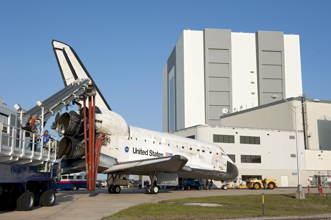 CAPE CANAVERAL, Fla. - Space shuttle Discovery, attached to a purge unit that pumps conditioned air into the shuttle while it is towed, awaits entry into Orbiter Processing Facility-2 at NASA's Kennedy Space Center in Florida. Discovery touched down on the Shuttle Landing Facility's Runway 15 at 11:57 a.m., bringing an end to its 39th and final spaceflight mission, STS-133. Discovery and its six-member STS-133 crew delivered the Permanent Multipurpose Module, packed with supplies and critical spare parts, as well as Robonaut 2, the dexterous humanoid astronaut helper, to the International Space Station.    Inside the processing facility, Discovery will be prepared for future public display.  Photo credit: NASA/Kim Shiflett