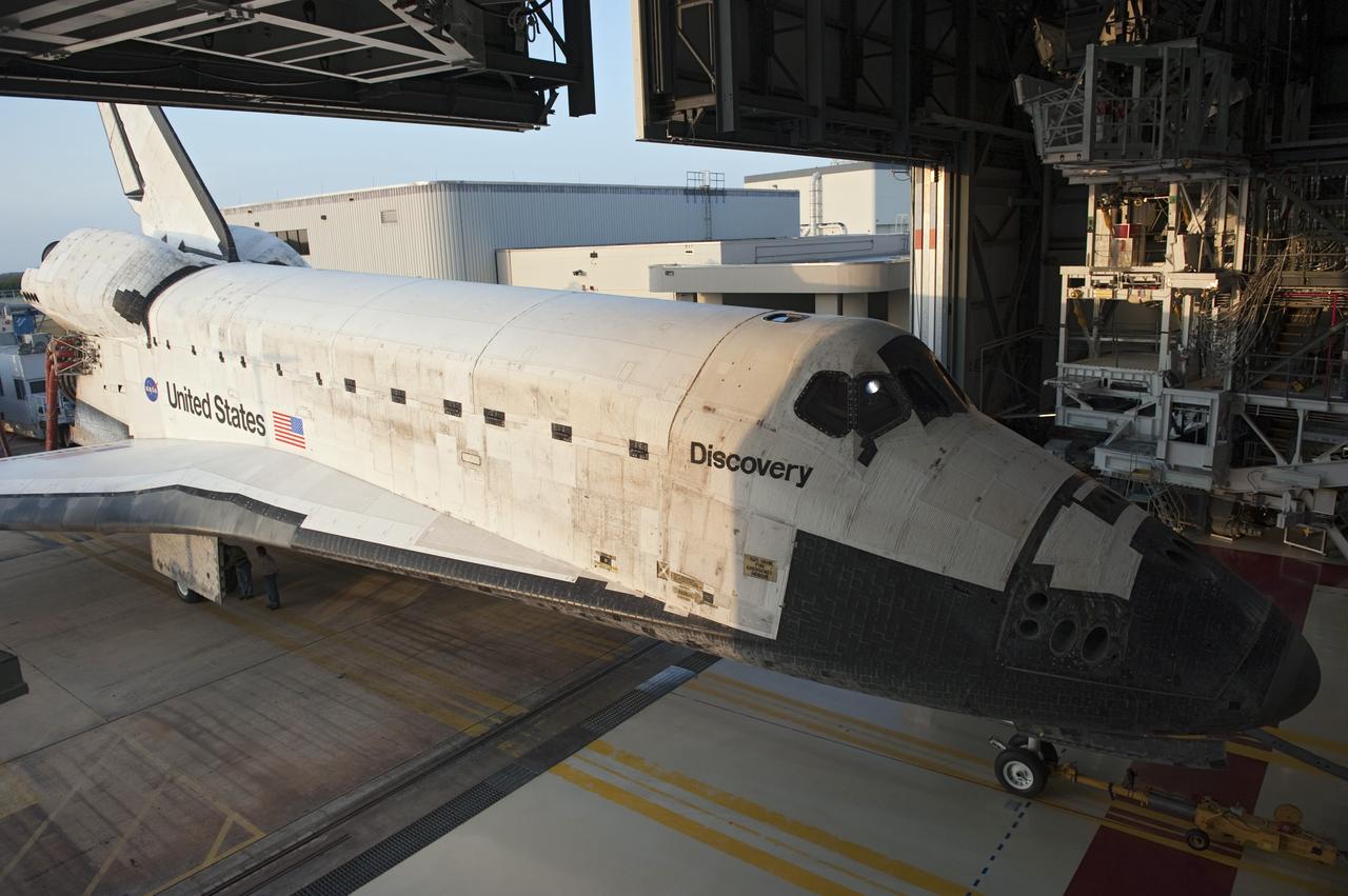 CAPE CANAVERAL, Fla. - Space shuttle Discovery slides through the open hangar door into Orbiter Processing Facility-2 at NASA's Kennedy Space Center in Florida. Discovery touched down on the Shuttle Landing Facility's Runway 15 at 11:57 a.m., bringing an end to its 39th and final spaceflight mission, STS-133. Discovery and its six-member STS-133 crew delivered the Permanent Multipurpose Module, packed with supplies and critical spare parts, as well as Robonaut 2, the dexterous humanoid astronaut helper, to the International Space Station.    Inside the processing facility, Discovery will be prepared for future public display.  Photo credit: NASA/Kim Shiflett