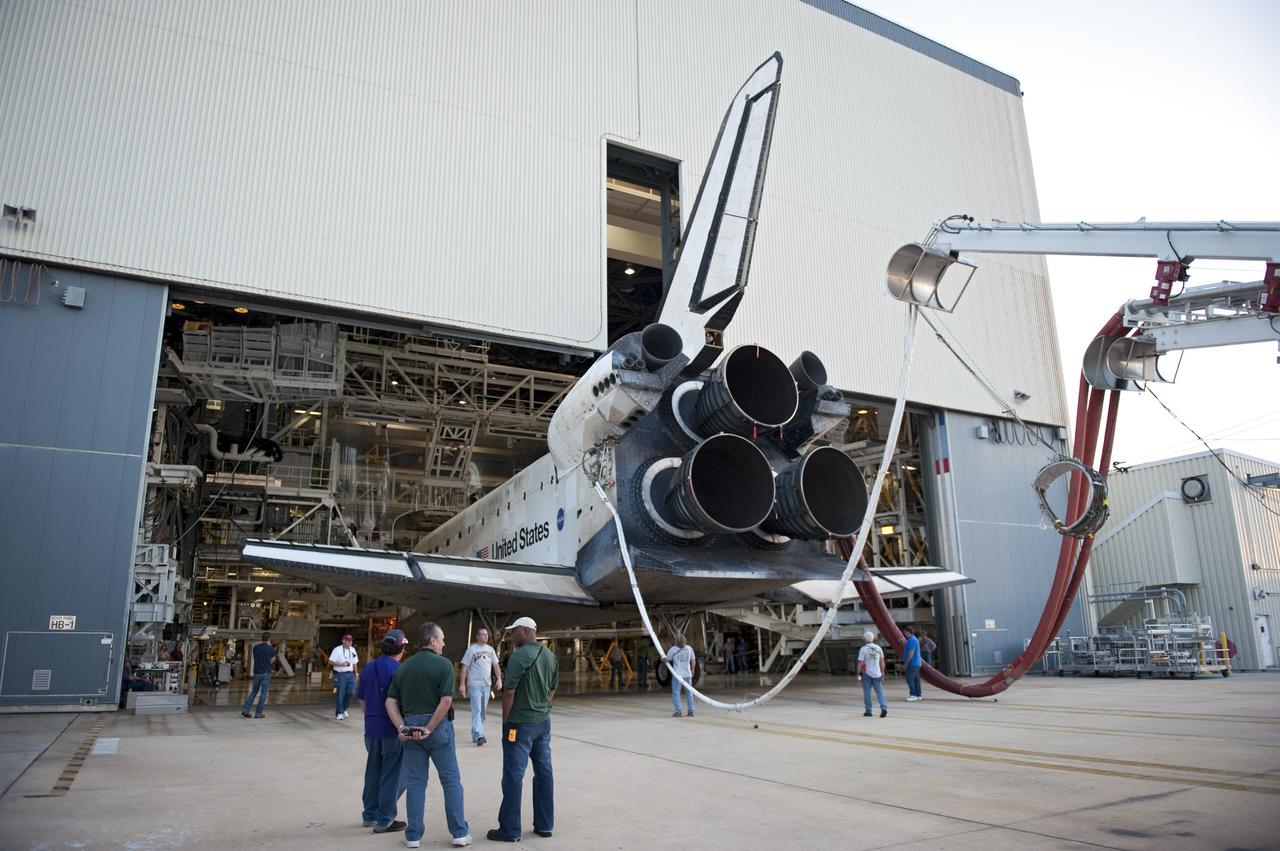 CAPE CANAVERAL, Fla. - Space shuttle Discovery is half in, half out of Orbiter Processing Facility-2 at NASA's Kennedy Space Center in Florida. Discovery touched down on the Shuttle Landing Facility's Runway 15 at 11:57 a.m., bringing an end to its 39th and final spaceflight mission, STS-133. Discovery and its six-member STS-133 crew delivered the Permanent Multipurpose Module, packed with supplies and critical spare parts, as well as Robonaut 2, the dexterous humanoid astronaut helper, to the International Space Station.    Inside the processing facility, Discovery will be prepared for future public display.  Photo credit: NASA/Kim Shiflett