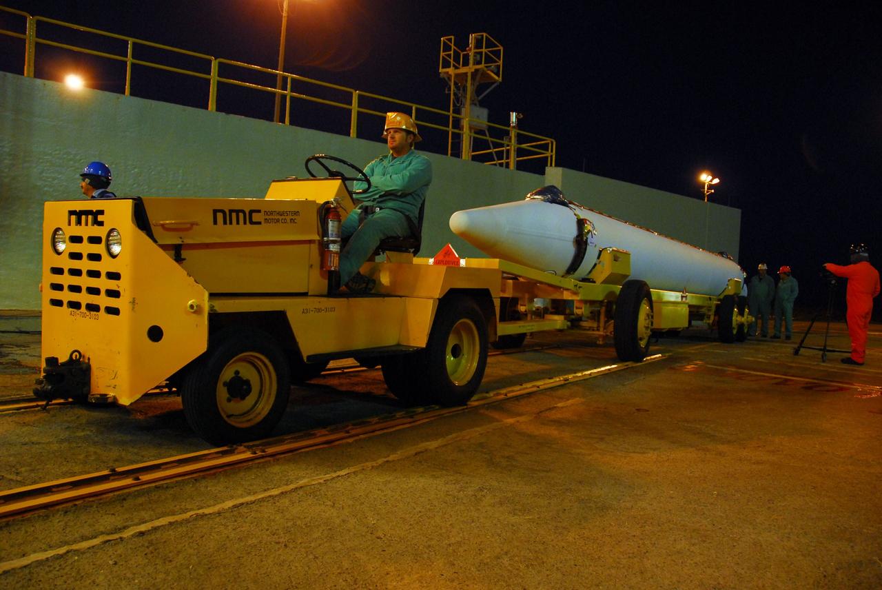 VANDENBERG AIR FORCE BASE, Calif. --Before the sun rises over Vandenberg Air Force Base in California, United Launch Alliance technicians prepare to move one of three Delta II solid rocket motors from the solid motor facility to Space Launch Complex-2 West (SLC-2W) atop a tug. ULA technician Eric Chambless is in the tug's driver seat. Scheduled to launch in June, the Delta II rocket will carry NASA's Aquarius satellite into low Earth orbit.    Aquarius' mission will be to provide monthly maps of global changes in sea surface salinity. By measuring ocean salinity from space, Aquarius will provide new insights into how the massive natural exchange of freshwater between the ocean, atmosphere and sea ice influences ocean circulation, weather and climate. Also going up with the satellite are optical and thermal cameras, a microwave radiometer and the SAC-D spacecraft, which were developed with the help of institutions in Italy, France, Canada and Argentina. Photo credit: VAFB/30th Space Wing