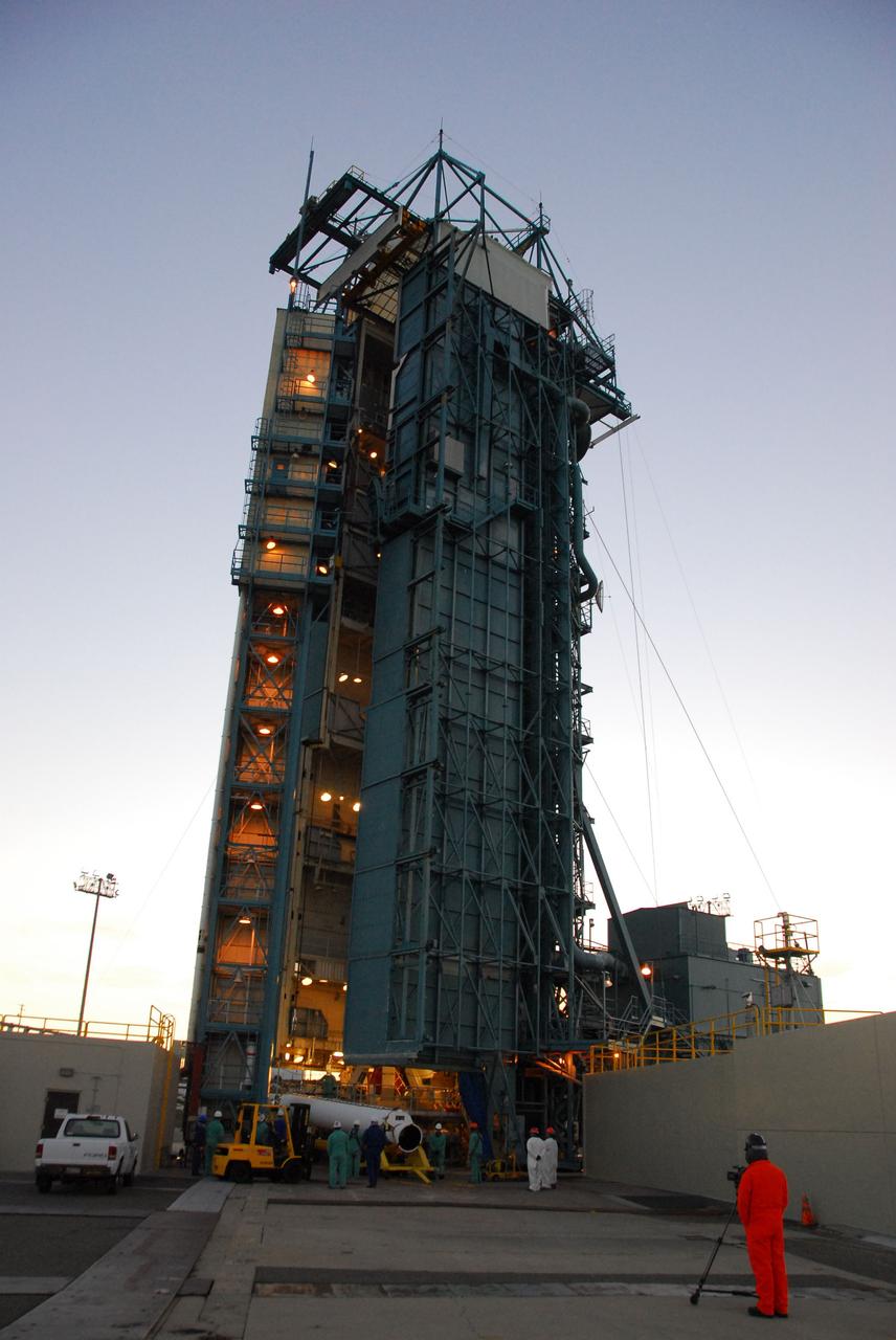 VANDENBERG AIR FORCE BASE, Calif. --As the sun rises over Vandenberg Air Force Base in California, United Launch Alliance technicians prepare to raise one of three Delta II solid rocket motors on the pad at Space Launch Complex-2 West (SLC-2W). Scheduled to launch in June, the Delta II rocket will carry NASA's Aquarius satellite into low Earth orbit.    Aquarius' mission will be to provide monthly maps of global changes in sea surface salinity. By measuring ocean salinity from space, Aquarius will provide new insights into how the massive natural exchange of freshwater between the ocean, atmosphere and sea ice influences ocean circulation, weather and climate. Also going up with the satellite are optical and thermal cameras, a microwave radiometer and the SAC-D spacecraft, which were developed with the help of institutions in Italy, France, Canada and Argentina. Photo credit: VAFB/30th Space Wing