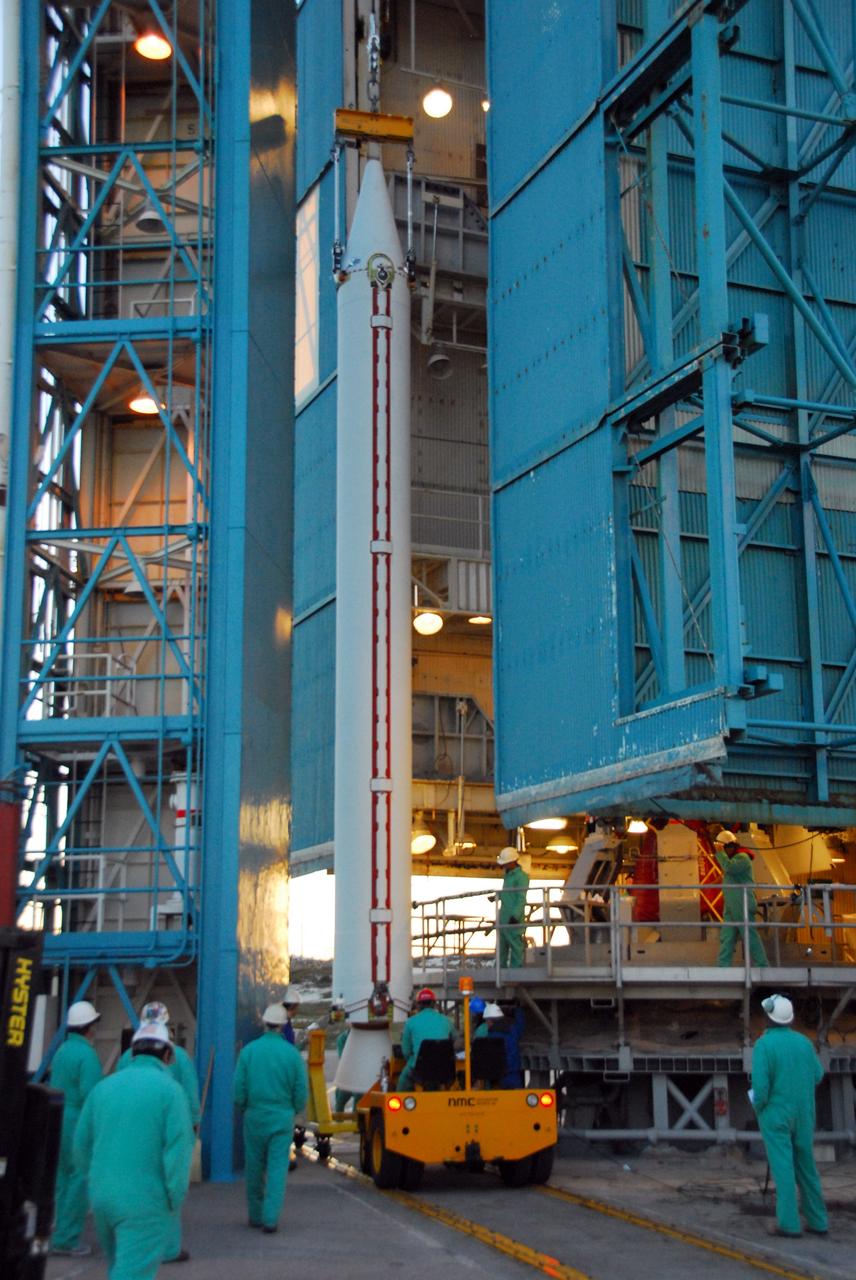 VANDENBERG AIR FORCE BASE, Calif. --As the sun rises over Vandenberg Air Force Base in California, a crane raises one of three United Launch Alliance Delta II solid rocket motors on the pad at Space Launch Complex-2 West (SLC-2W). Scheduled to launch in June, the Delta II rocket will carry NASA's Aquarius satellite into low Earth orbit.    Aquarius' mission will be to provide monthly maps of global changes in sea surface salinity. By measuring ocean salinity from space, Aquarius will provide new insights into how the massive natural exchange of freshwater between the ocean, atmosphere and sea ice influences ocean circulation, weather and climate. Also going up with the satellite are optical and thermal cameras, a microwave radiometer and the SAC-D spacecraft, which were developed with the help of institutions in Italy, France, Canada and Argentina. Photo credit: VAFB/30th Space Wing