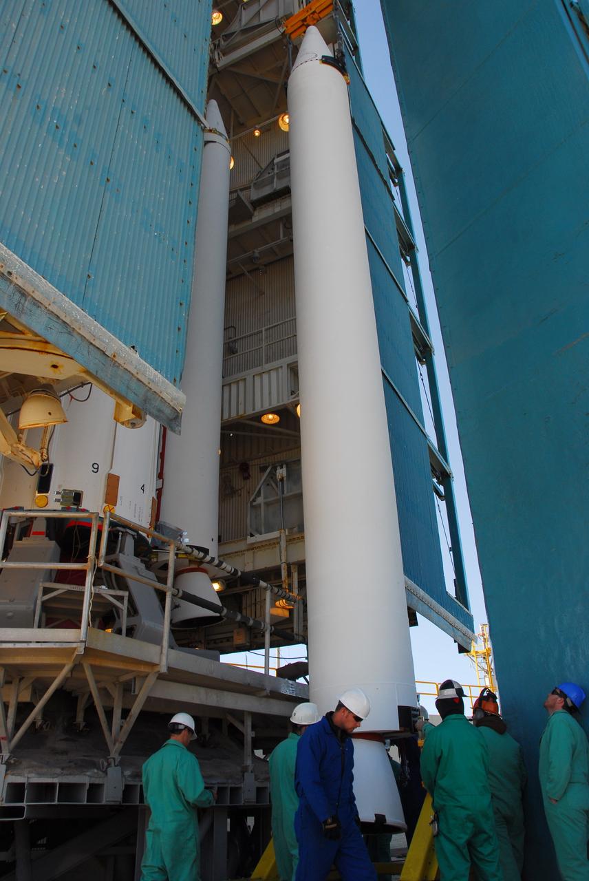 VANDENBERG AIR FORCE BASE, Calif. --At Vandenberg Air Force Base in California, a crane raises one of three United Launch Alliance Delta II solid rocket motors on the pad at Space Launch Complex-2 West (SLC-2W). A second motor was installed earlier in the morning. Scheduled to launch in June, the Delta II rocket will carry NASA's Aquarius satellite into low Earth orbit.    Aquarius' mission will be to provide monthly maps of global changes in sea surface salinity. By measuring ocean salinity from space, Aquarius will provide new insights into how the massive natural exchange of freshwater between the ocean, atmosphere and sea ice influences ocean circulation, weather and climate. Also going up with the satellite are optical and thermal cameras, a microwave radiometer and the SAC-D spacecraft, which were developed with the help of institutions in Italy, France, Canada and Argentina. Photo credit: VAFB/30th Space Wing
