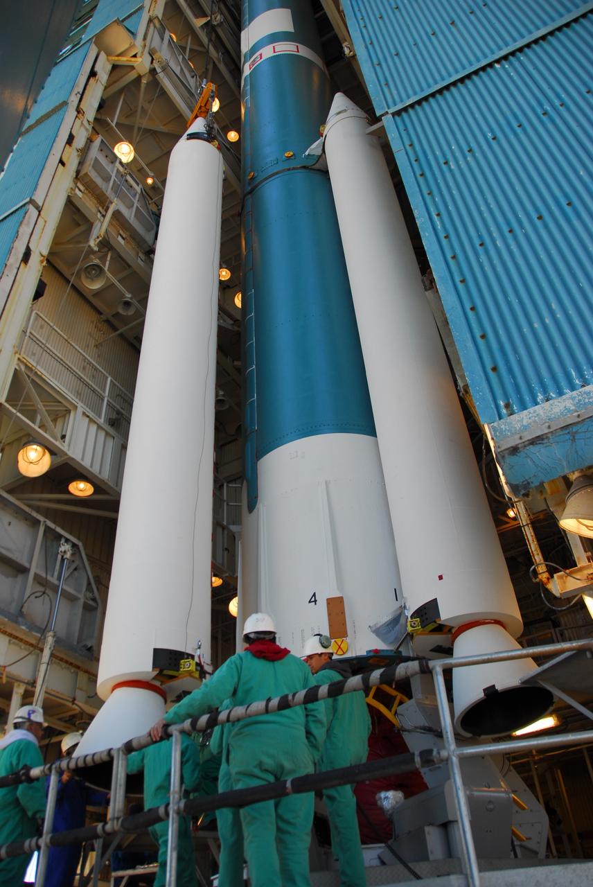 VANDENBERG AIR FORCE BASE, Calif. --At Vandenberg Air Force Base in California, a crane raises one of three United Launch Alliance Delta II solid rocket motors on the pad at Space Launch Complex-2 West (SLC-2W). A second motor was installed earlier in the morning. Scheduled to launch in June, the Delta II rocket will carry NASA's Aquarius satellite into low Earth orbit.    Aquarius' mission will be to provide monthly maps of global changes in sea surface salinity. By measuring ocean salinity from space, Aquarius will provide new insights into how the massive natural exchange of freshwater between the ocean, atmosphere and sea ice influences ocean circulation, weather and climate. Also going up with the satellite are optical and thermal cameras, a microwave radiometer and the SAC-D spacecraft, which were developed with the help of institutions in Italy, France, Canada and Argentina. Photo credit: VAFB/30th Space Wing