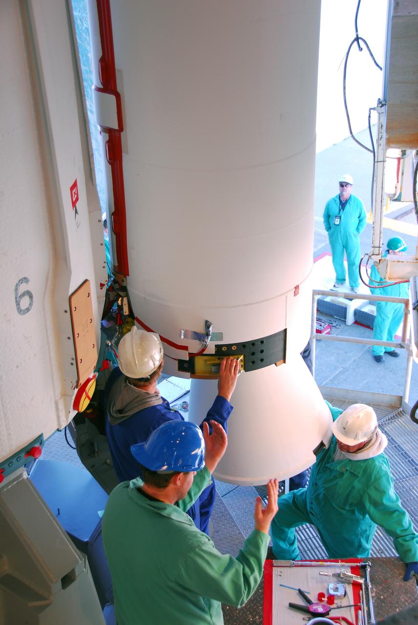 VANDENBERG AIR FORCE BASE, Calif. --At Vandenberg Air Force Base in California, United Launch Alliance technicians finish installing one of three Delta II solid rocket motors on the pad at Space Launch Complex-2 West (SLC-2W). Scheduled to launch in June, the Delta II rocket will carry NASA's Aquarius satellite into low Earth orbit.    Aquarius' mission will be to provide monthly maps of global changes in sea surface salinity. By measuring ocean salinity from space, Aquarius will provide new insights into how the massive natural exchange of freshwater between the ocean, atmosphere and sea ice influences ocean circulation, weather and climate. Also going up with the satellite are optical and thermal cameras, a microwave radiometer and the SAC-D spacecraft, which were developed with the help of institutions in Italy, France, Canada and Argentina. Photo credit: VAFB/30th Space Wing