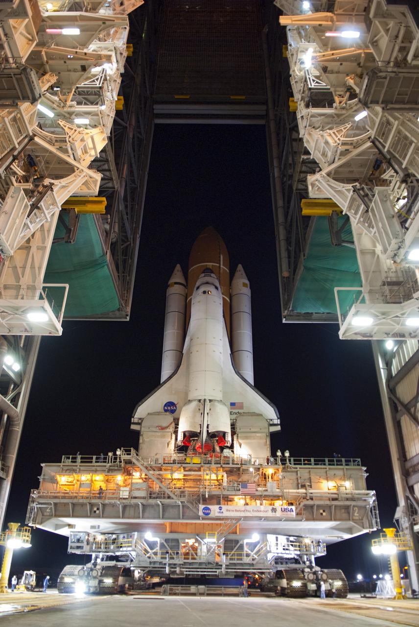 CAPE CANAVERAL, Fla. -- Space shuttle Endeavour begins its slow move from High Bay 3 in the Vehicle Assembly Building to Launch Pad 39A at NASA's Kennedy Space Center in Florida at 7:56 p.m. EST. The 3.4-mile trek, known as "rollout," will take about seven hours to complete. This is the final scheduled rollout for Endeavour, which is attached to its external fuel tank and solid rocket boosters atop a crawler-transporter. Endeavour and its six STS-134 crew members will deliver the Express Logistics Carrier-3, Alpha Magnetic Spectrometer-2 (AMS), a high-pressure gas tank, additional spare parts for the Dextre robotic helper and micrometeoroid debris shields to the International Space Station on the shuttle's final spaceflight. Launch is targeted for April 19 at 7:48 p.m. EDT. For more information visit, www.nasa.gov/mission_pages/shuttle/shuttlemissions/sts134/index.html. Photo credit: NASA/Jim Grossmann